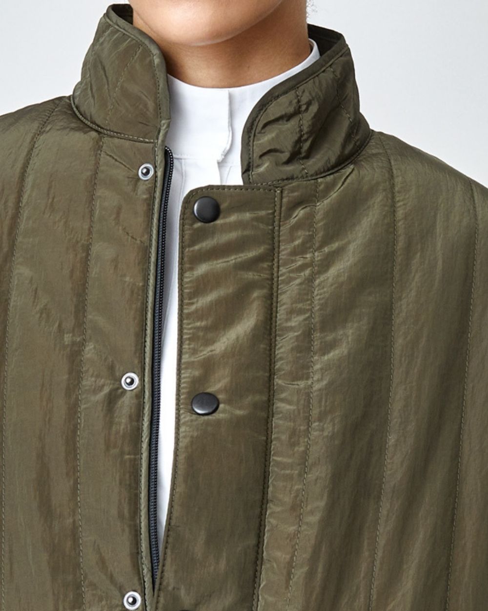 Green Quilted Riding Vest with stand-up collar and front zipper, featuring multiple pockets and embroidered logo.