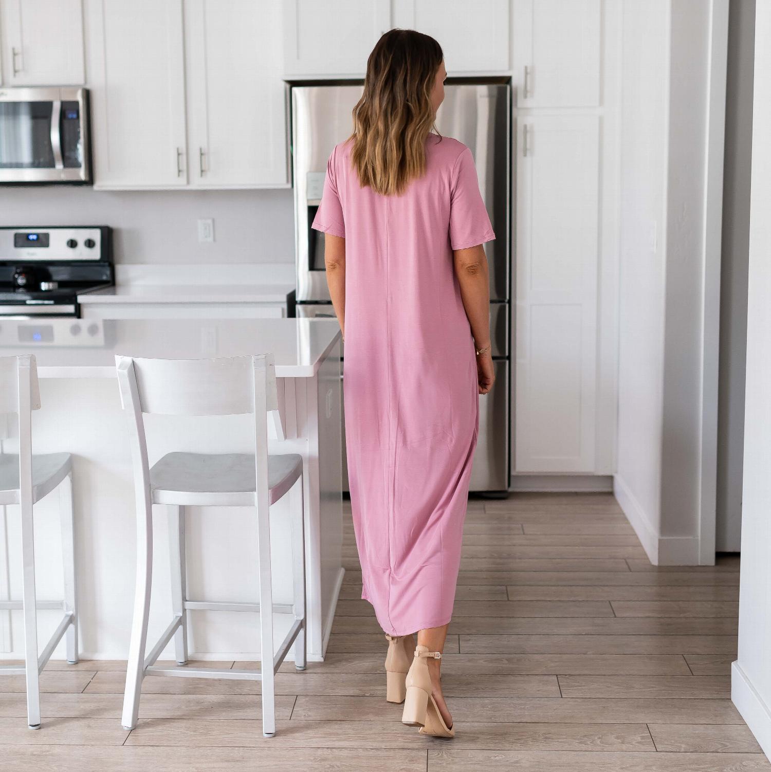 A stylish woman wearing a Real Modal Short Sleeve Round Neck Maxi Dress, showcasing its relaxed fit and ankle-length design in a casual setting.