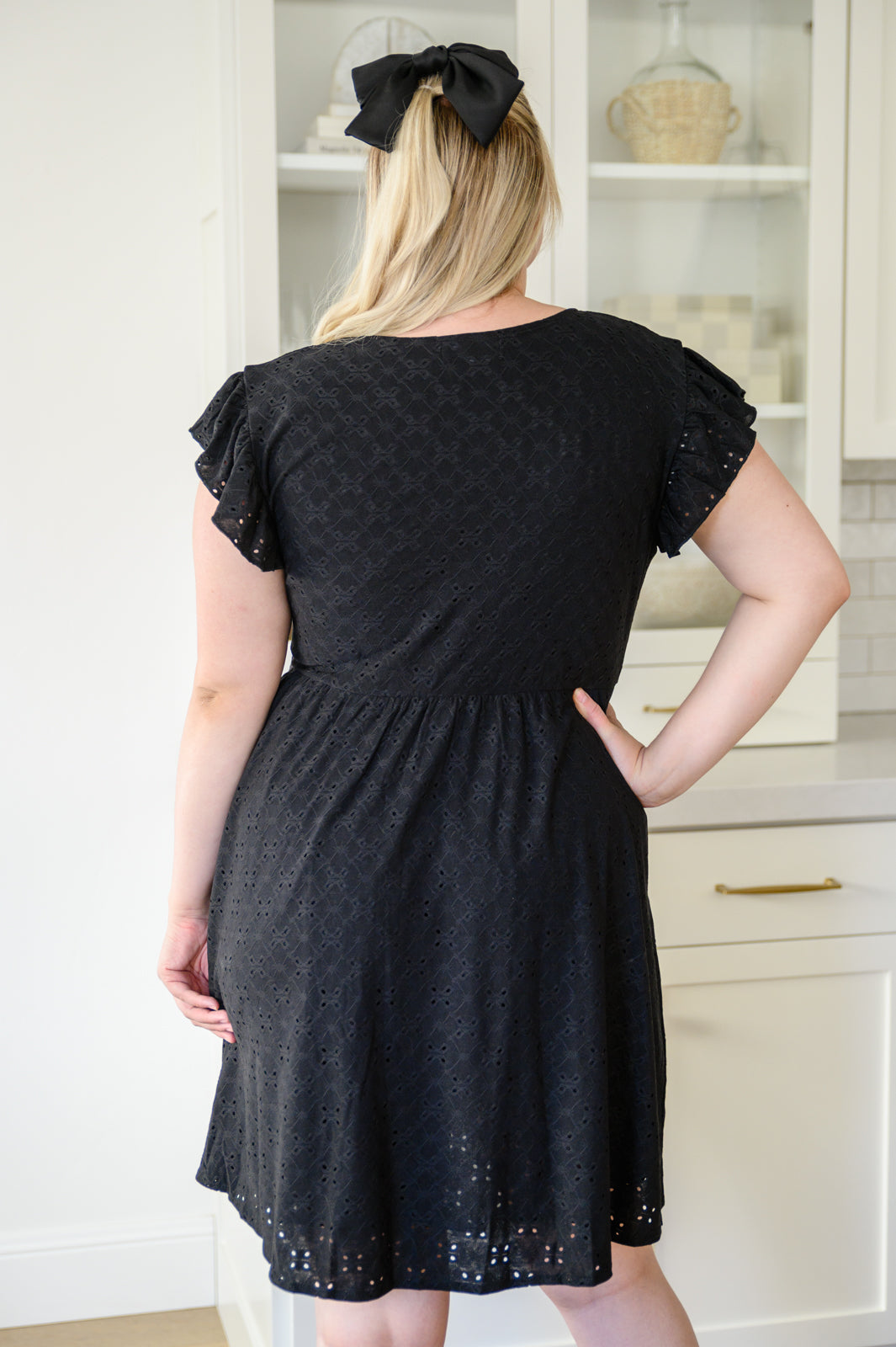 Rebecca Ruffle Eyelet Dress displayed in seven colors, showcasing its soft fabric, elastic waistband, and flattering design.