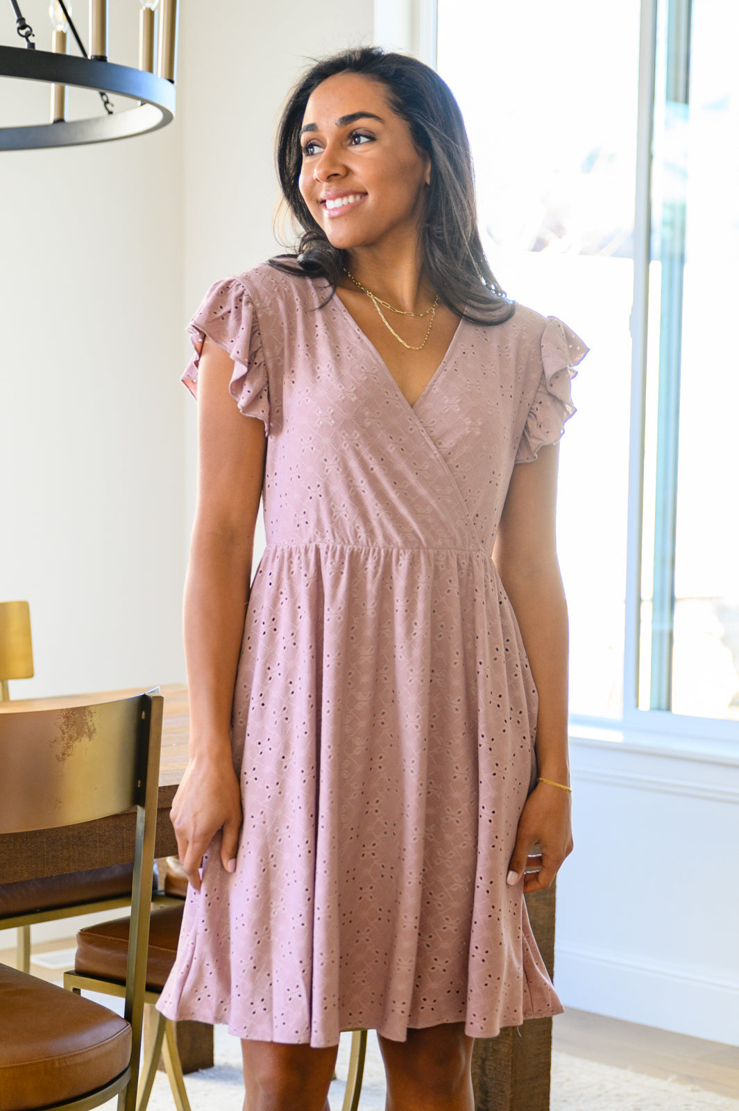 Rebecca Ruffle Eyelet Dress displayed in seven colors, showcasing its soft fabric, elastic waistband, and flattering design.