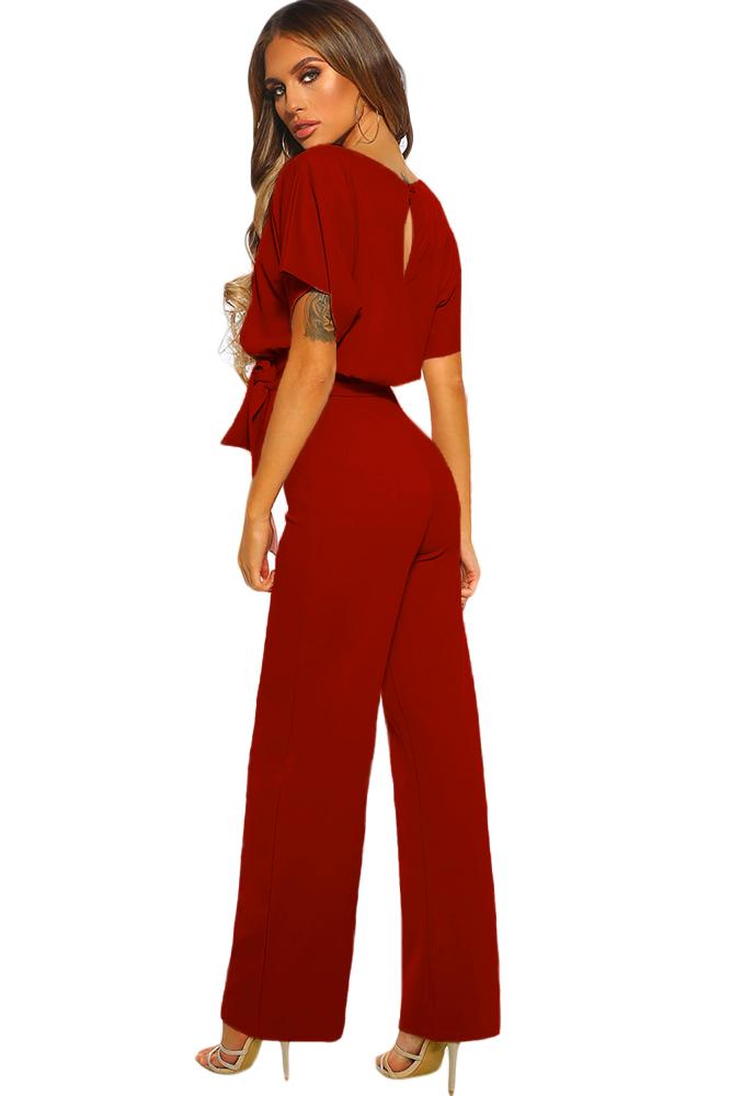 A stylish red jumpsuit featuring short sleeves, a belted waist, and wide leg design, perfect for summer occasions.