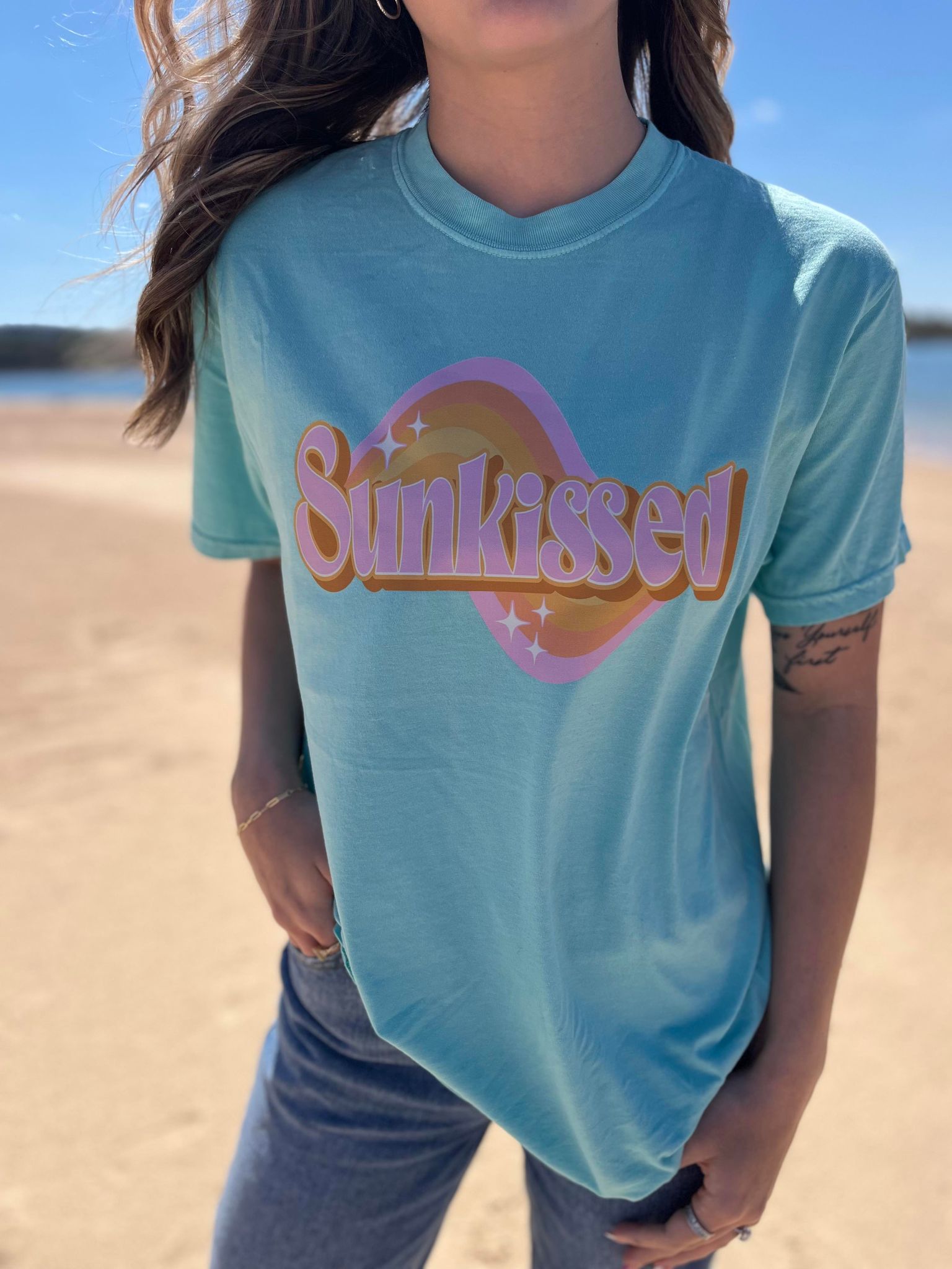 A stylish Lagoon Blue Retro Sunkissed Tee displayed on a mannequin, showcasing its vibrant color and comfortable fit.