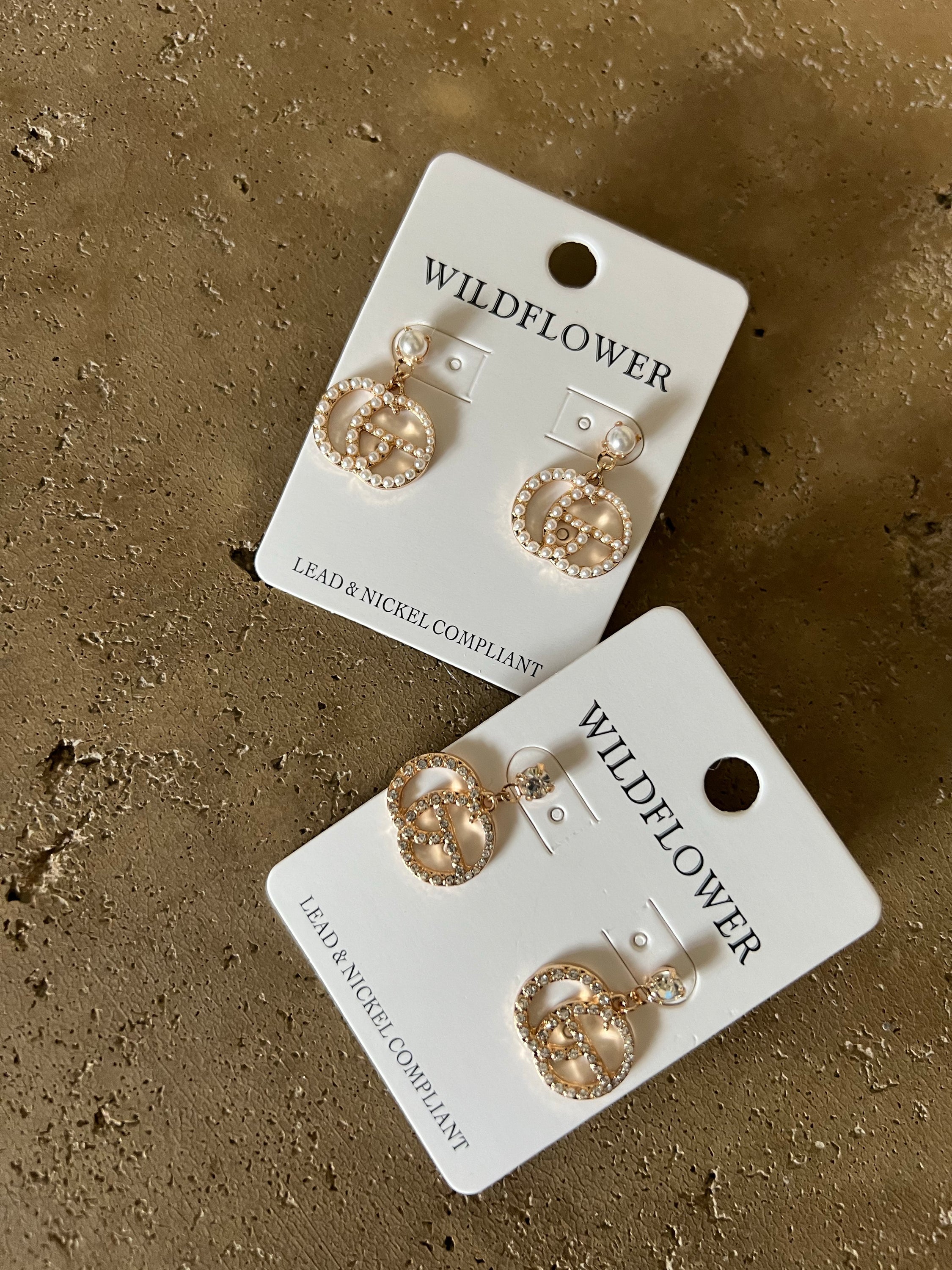 Elegant rhinestone and pearl inspired dangle earrings, showcasing a trendy design perfect for any outfit.