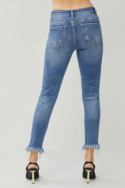RISEN Distressed Frayed Hem Slim Jeans showcasing a stylish distressed design with a frayed hem, perfect for a trendy look.