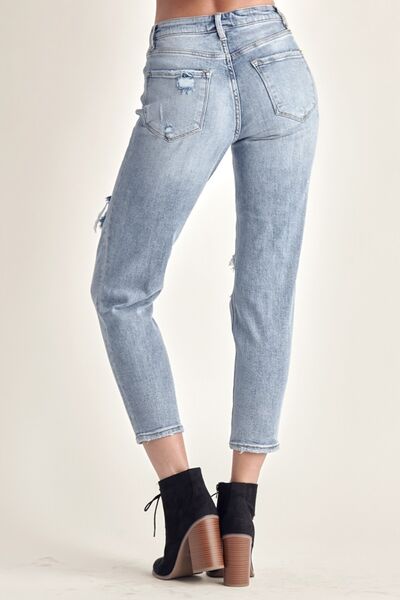 A pair of RISEN Distressed Slim Cropped Jeans showcasing a stylish slim fit with distressed details and a cropped length, perfect for modern outfits.