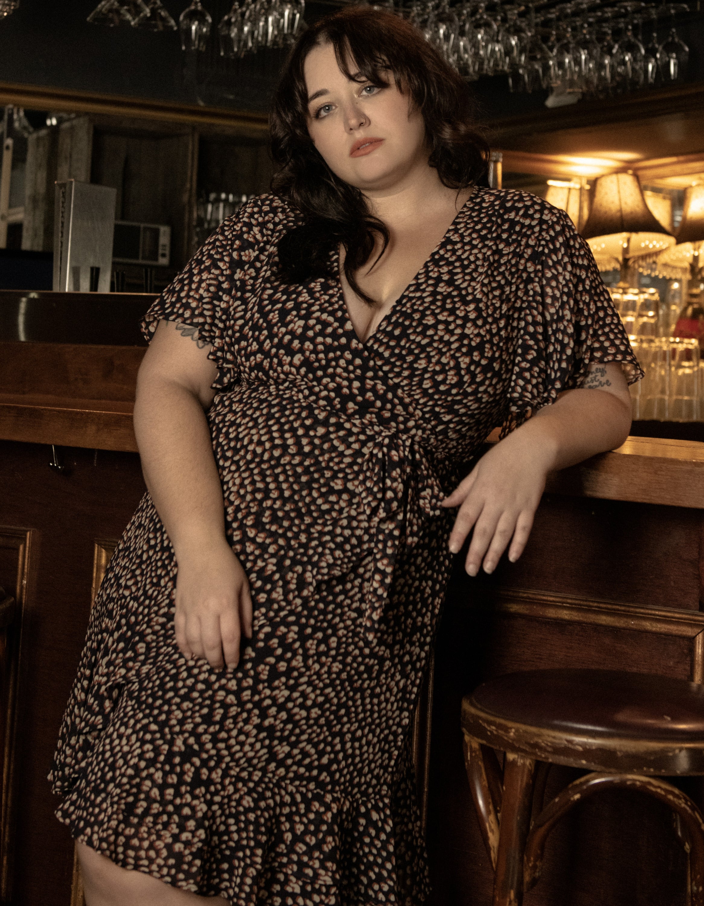 Romane Dress Cross-Over Wrap in navy with flutter sleeves and a floral print, featuring a removable belt and flounce hemline.