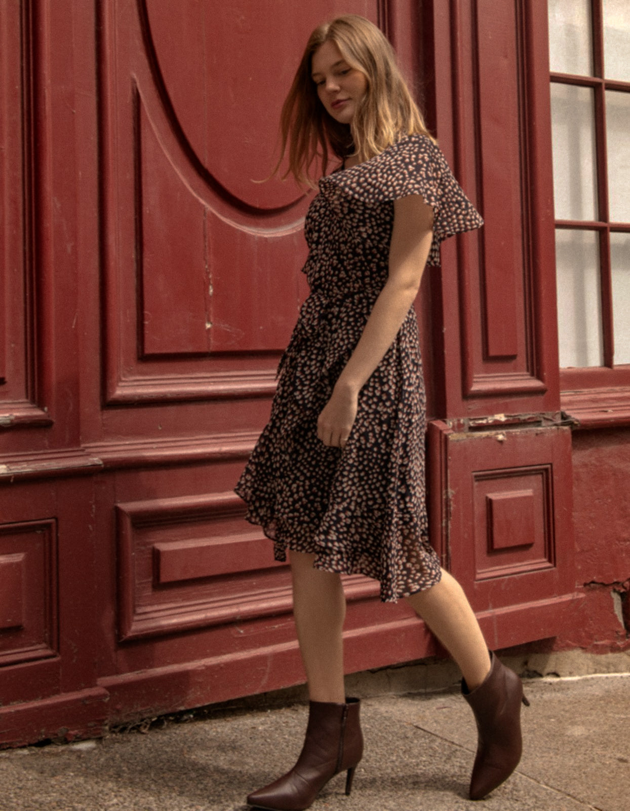 Romane Dress Cross-Over Wrap in navy with flutter sleeves and a floral print, featuring a removable belt and flounce hemline.