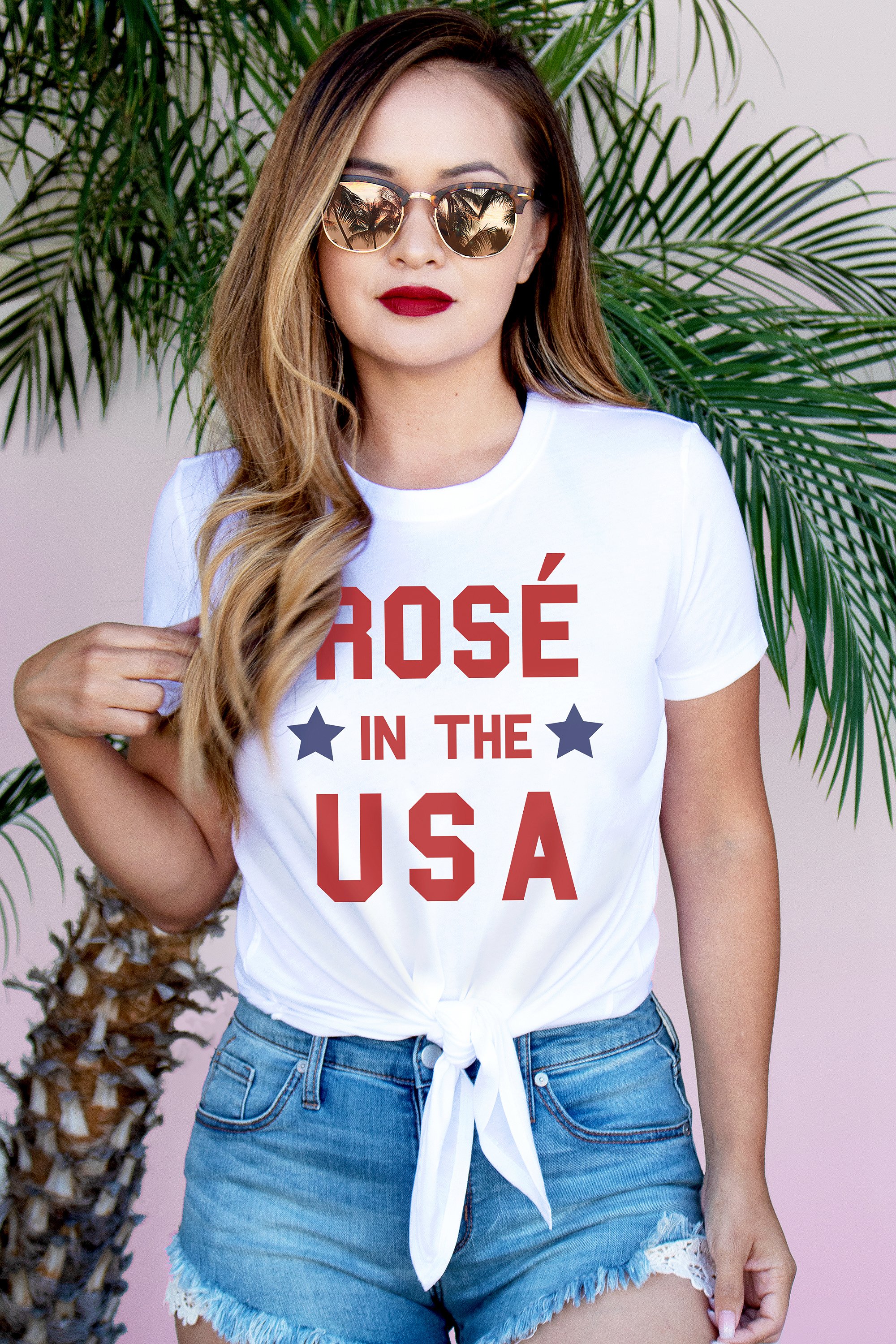 A stylish white crop top featuring the phrase 'Rosé in USA' with a front tie, perfect for summer celebrations.
