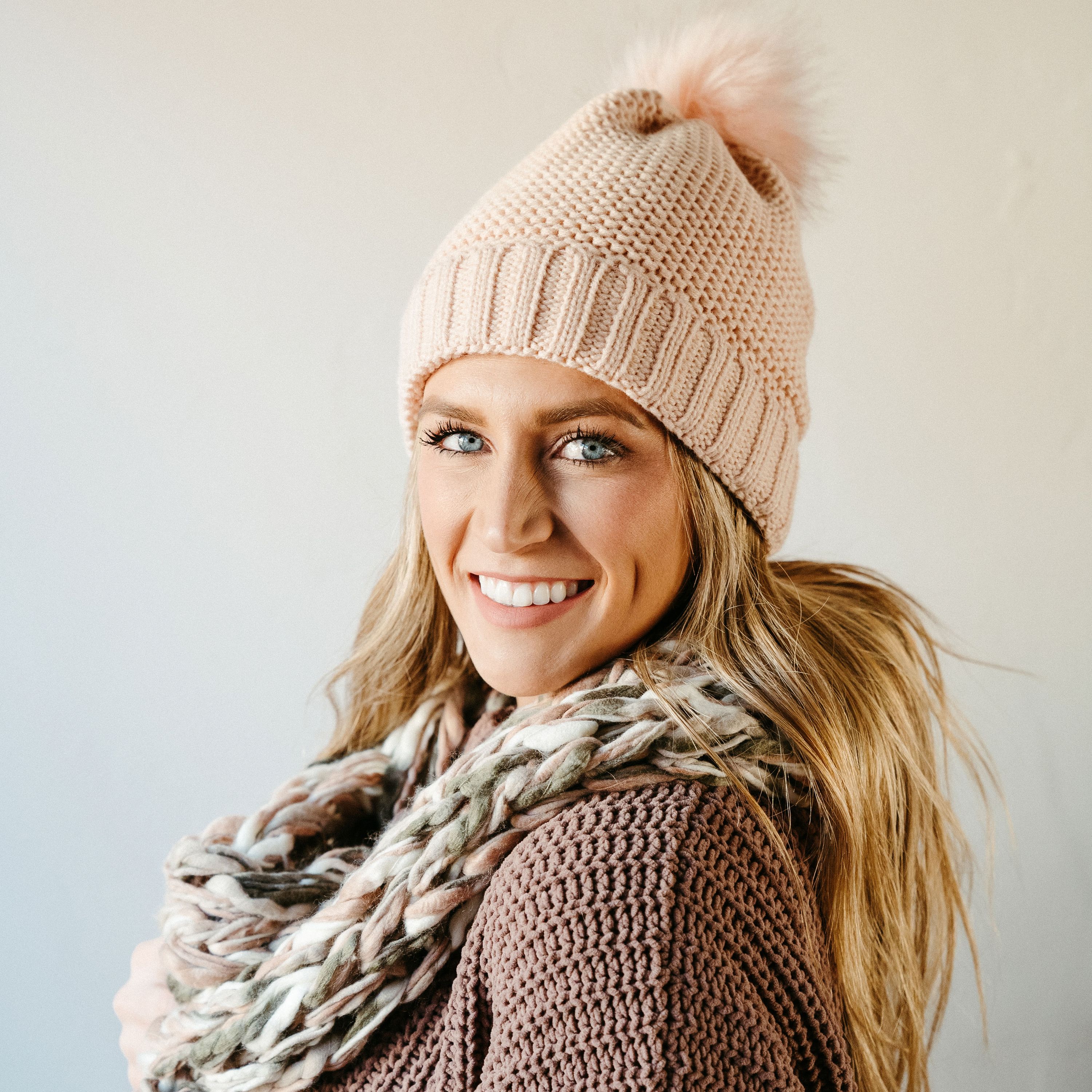 A cozy rose thick knit infinity scarf, elegantly draped, showcasing its soft texture and warm design, perfect for winter wear.