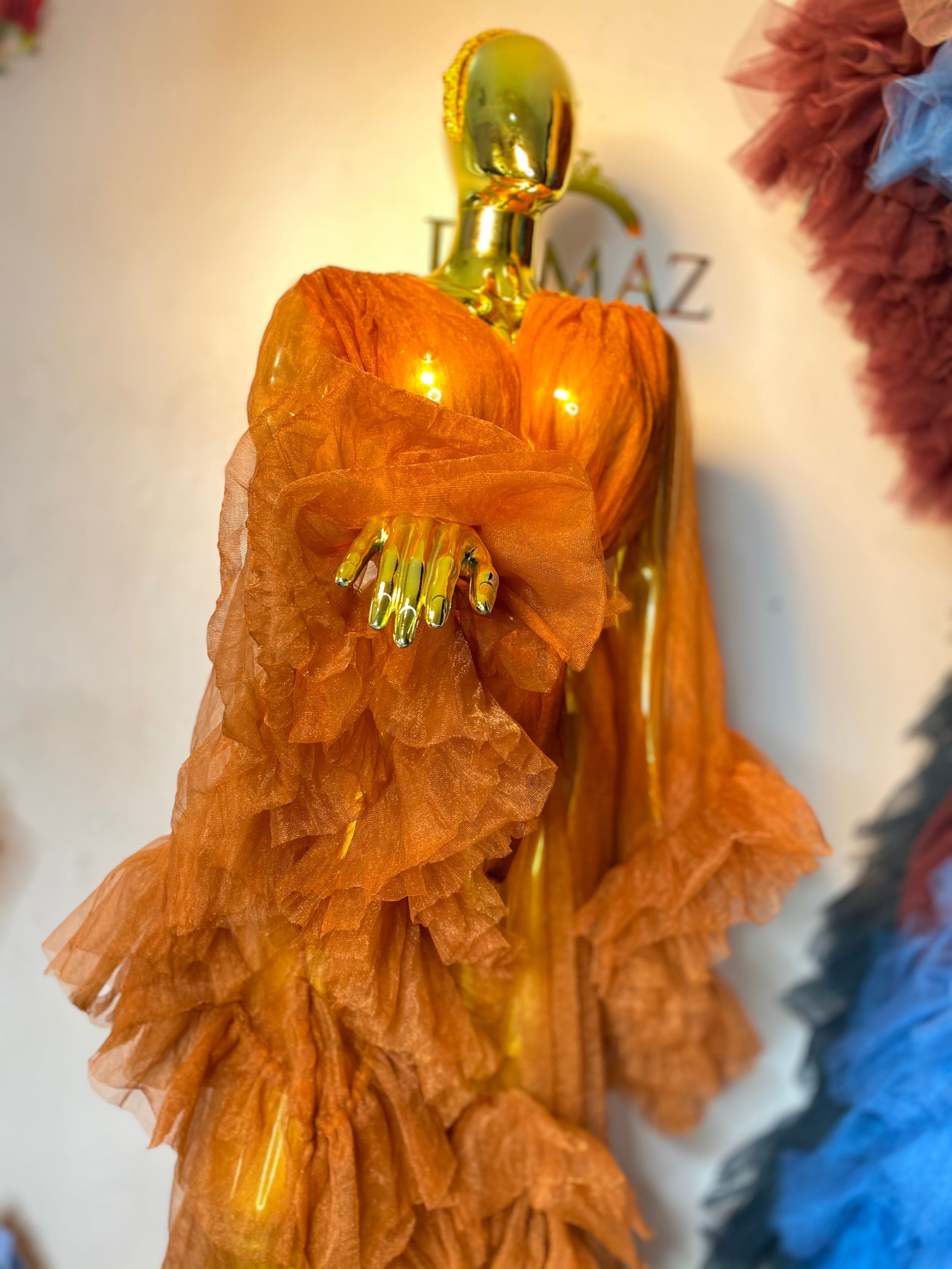 RTS AURORA dress featuring ruffled sleeves, open slit, and chain appliqué details in black color.