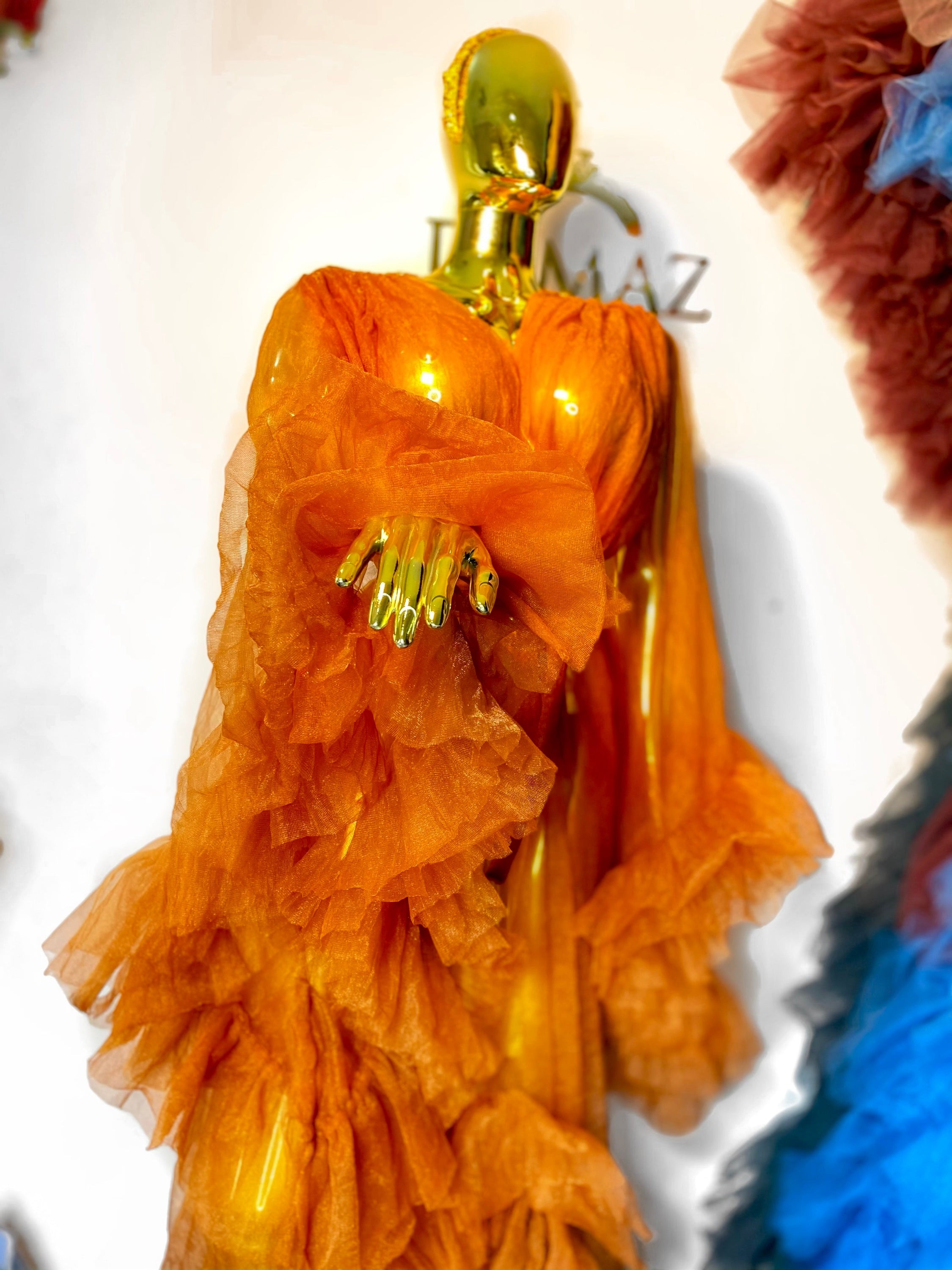 RTS AURORA dress featuring ruffled sleeves, open slit, and chain appliqué details in black color.