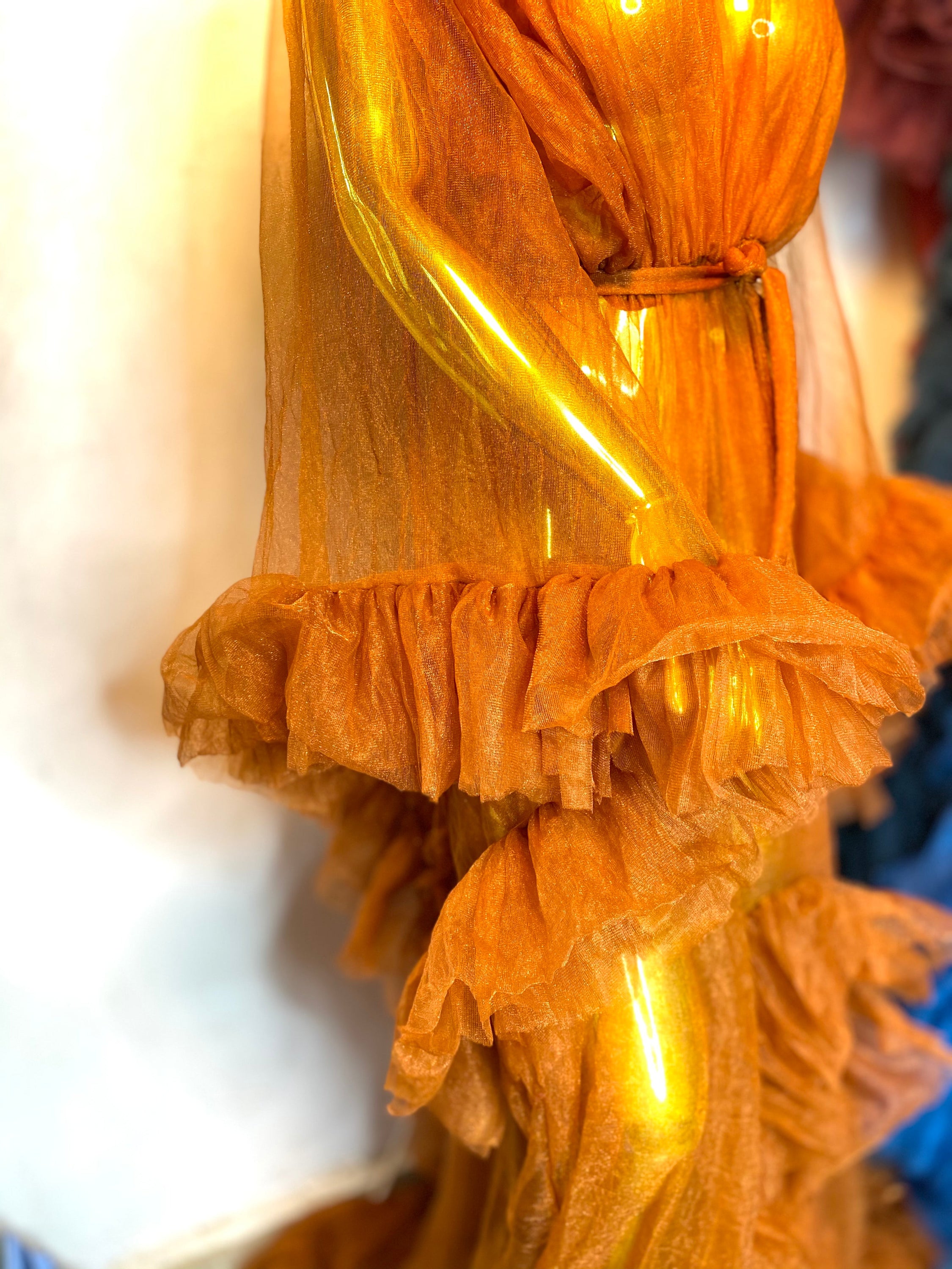 RTS AURORA dress featuring ruffled sleeves, open slit, and chain appliqué details in black color.