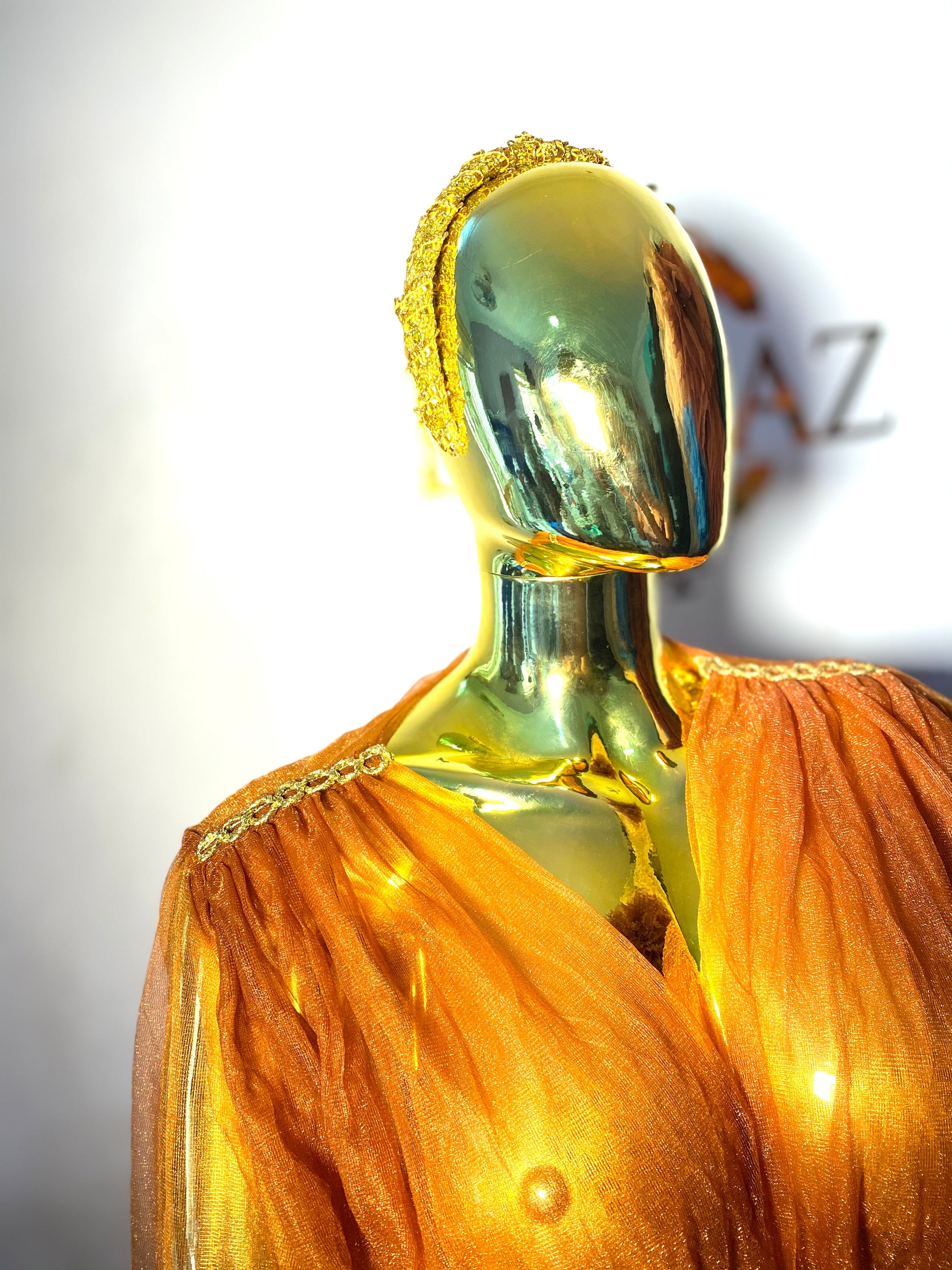 RTS AURORA dress featuring ruffled sleeves, open slit, and chain appliqué details in black color.