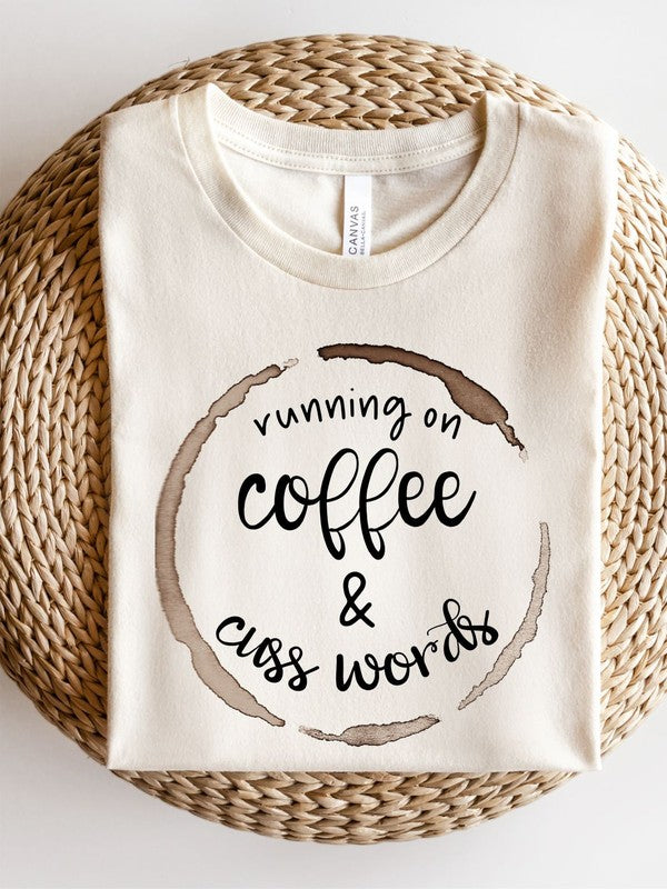 A stylish unisex crew neck tee featuring the phrase 'Running on Coffee and Cuss Words' printed on it, made from soft cotton fabric.