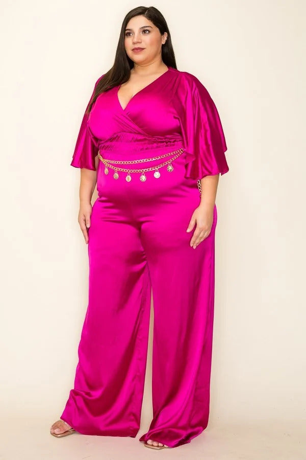 A stylish magenta satin jumpsuit featuring a wrap front, short sleeves, and a smocked waist with a chain belt.