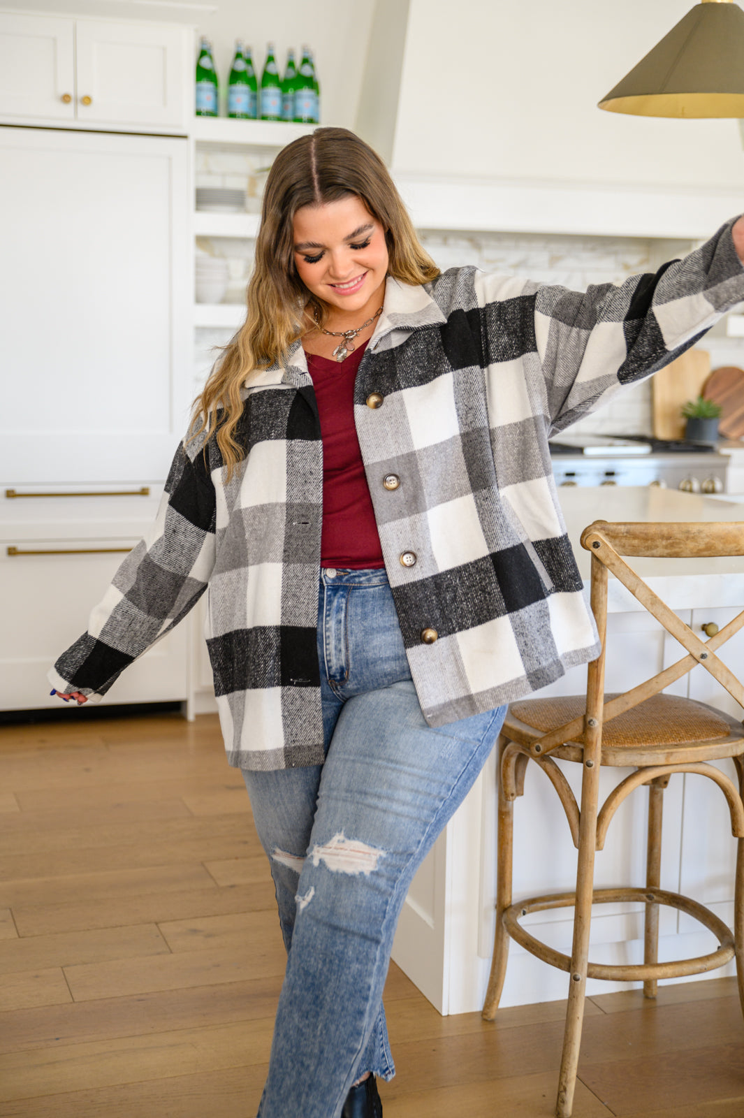 A stylish Saturday Stroll Brushed Tonal Plaid Shacket in black, white, and gray plaid, featuring a collared neckline, button front, and side pockets.