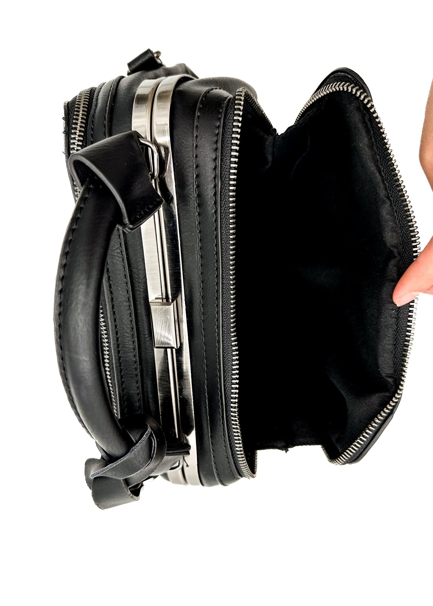 Savvy Handbag in Black featuring laser cut design and adjustable strap, showcasing its stylish faux leather finish and multiple compartments.