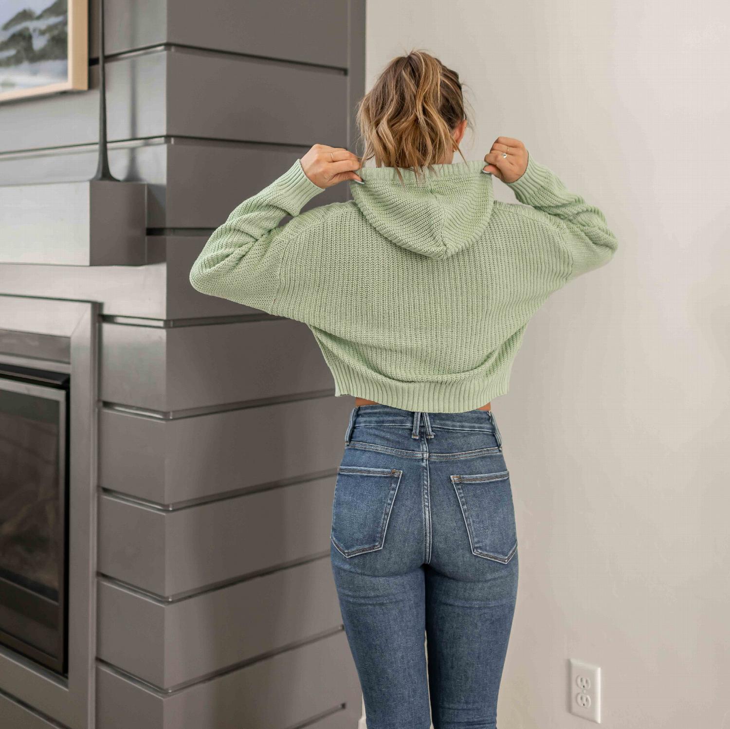 A stylish semi-crop wide drawstring hooded sweater in light colors, featuring a flirty fitted design and wide elastic waistband.