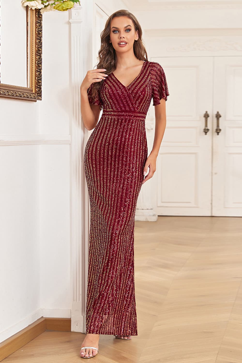 A stylish Sequin Flutter Sleeve Formal Dress featuring a striped pattern, flutter sleeves, and a surplice neckline, perfect for formal occasions.
