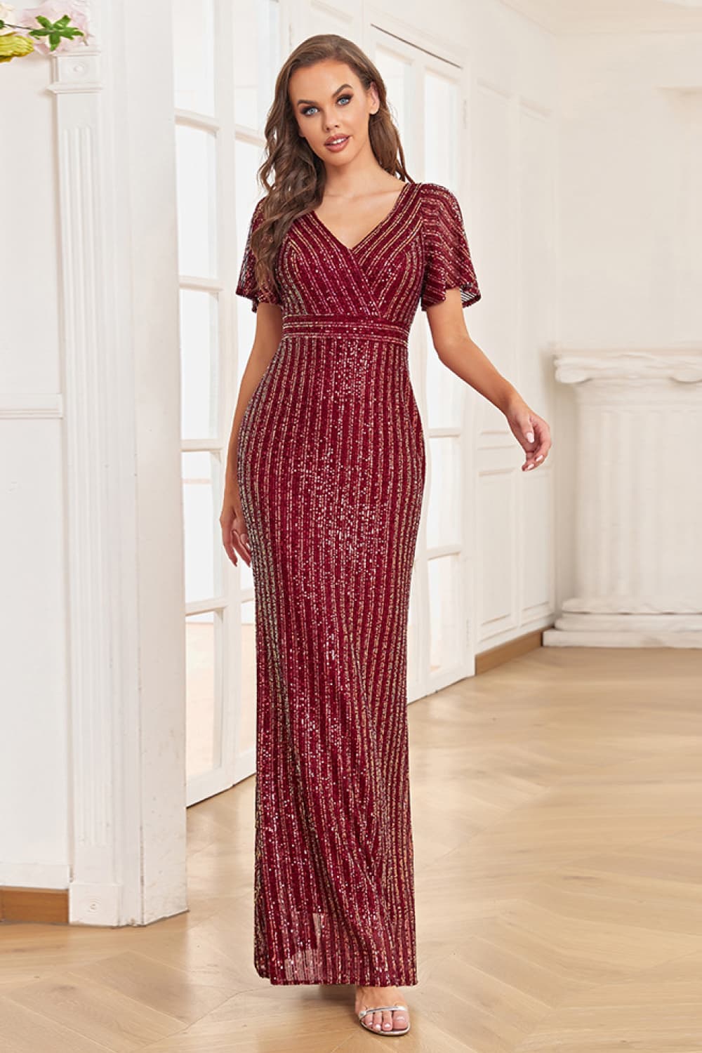A stylish Sequin Flutter Sleeve Formal Dress featuring a striped pattern, flutter sleeves, and a surplice neckline, perfect for formal occasions.