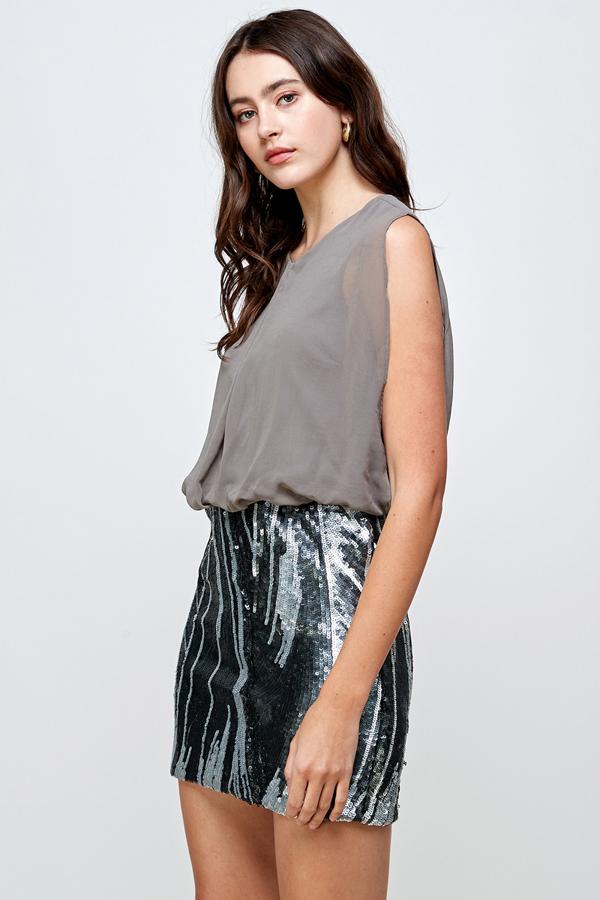 A glamorous sequin skirt paired with a sleeveless blouson top, perfect for parties.