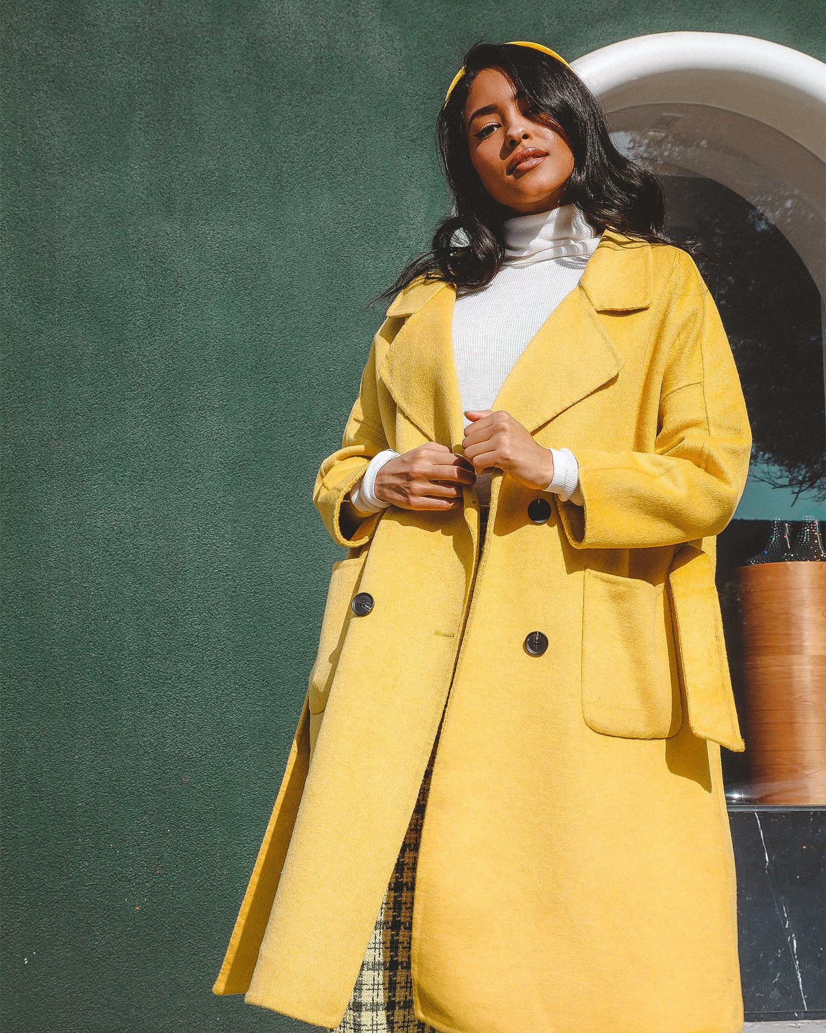 Serena Double Breasted Trench Coat in cozy wool with contrasting buttons and a tie waist, showcasing a sleek silhouette.