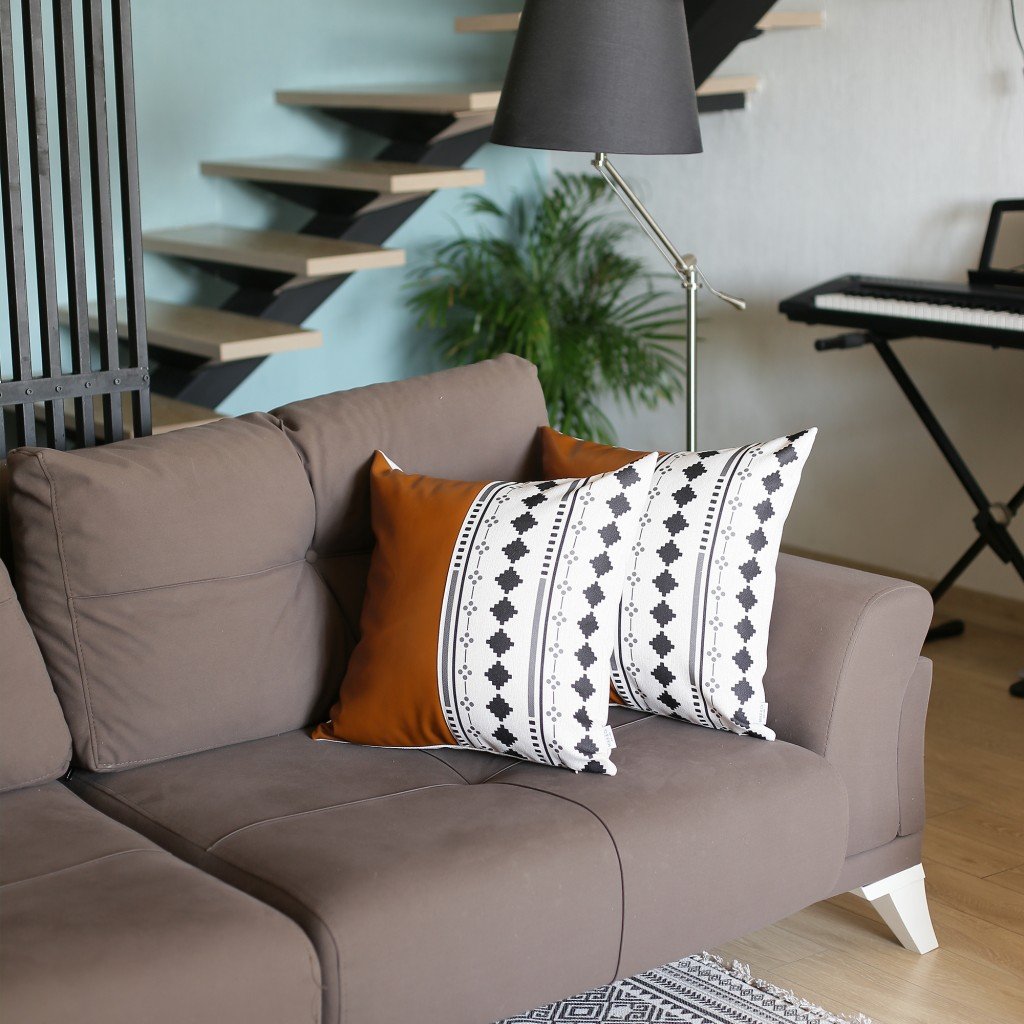 Set of 2 lumbar pillow covers featuring half brown faux leather and diamond patterns on a pearl white background, showcasing a modern design.