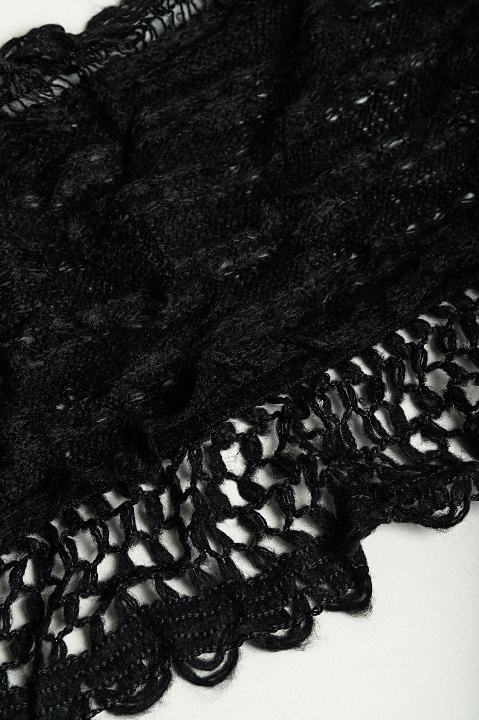 Set of 2 knitted scarves in white and black, showcasing their soft texture and stylish design.