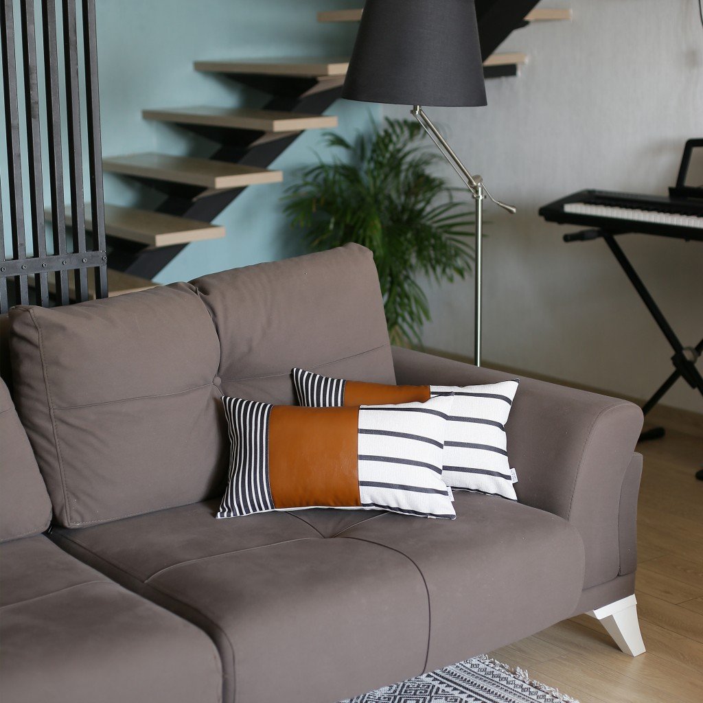 Set of 2 striped and bright brown faux leather lumbar pillow covers with a unique design, featuring a polyester base and faux leather section.