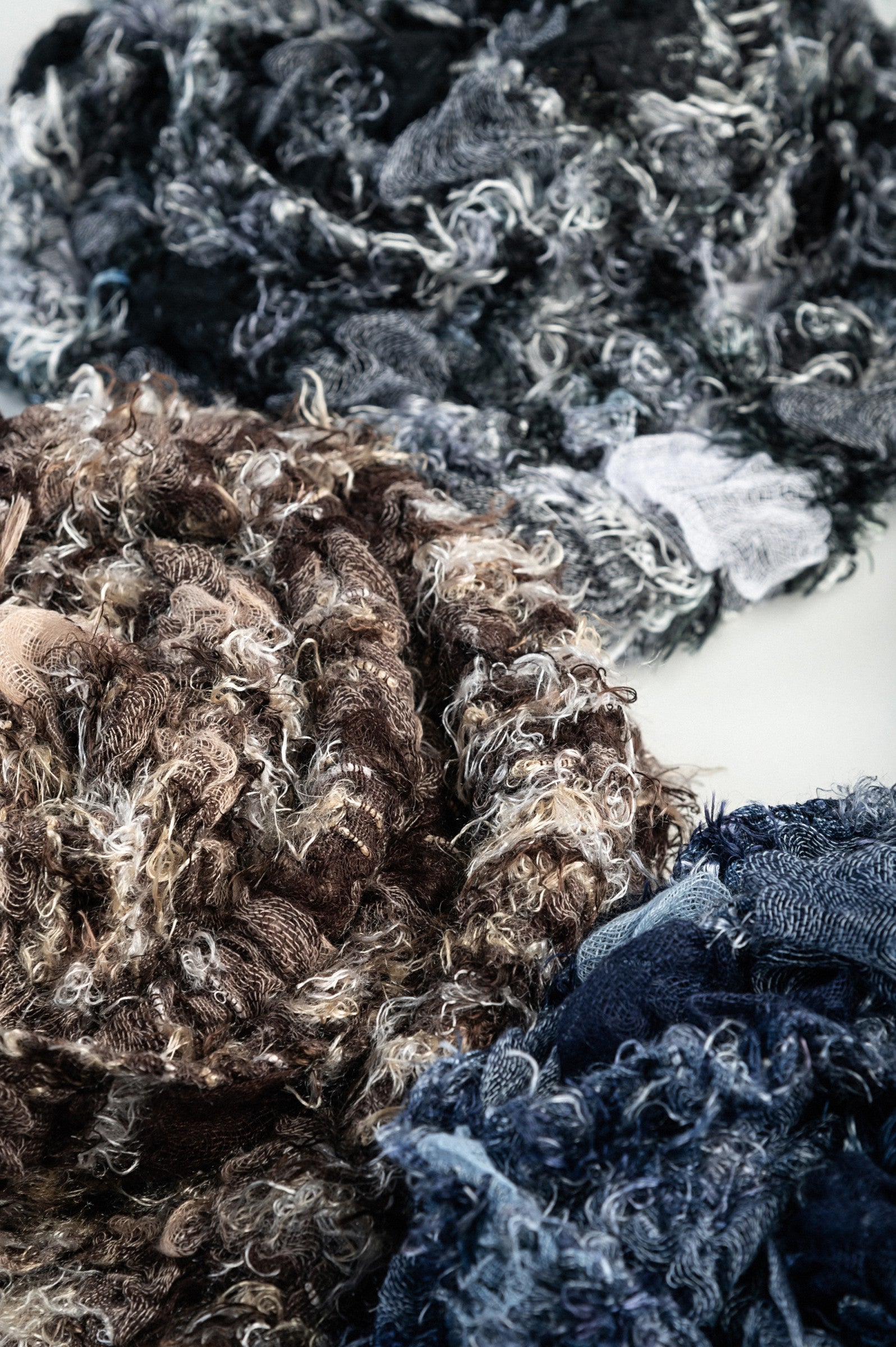 Set of 3 elegant scarves in black, blue, and brown, made from 100% viscose, showcasing their soft texture and vibrant colors.