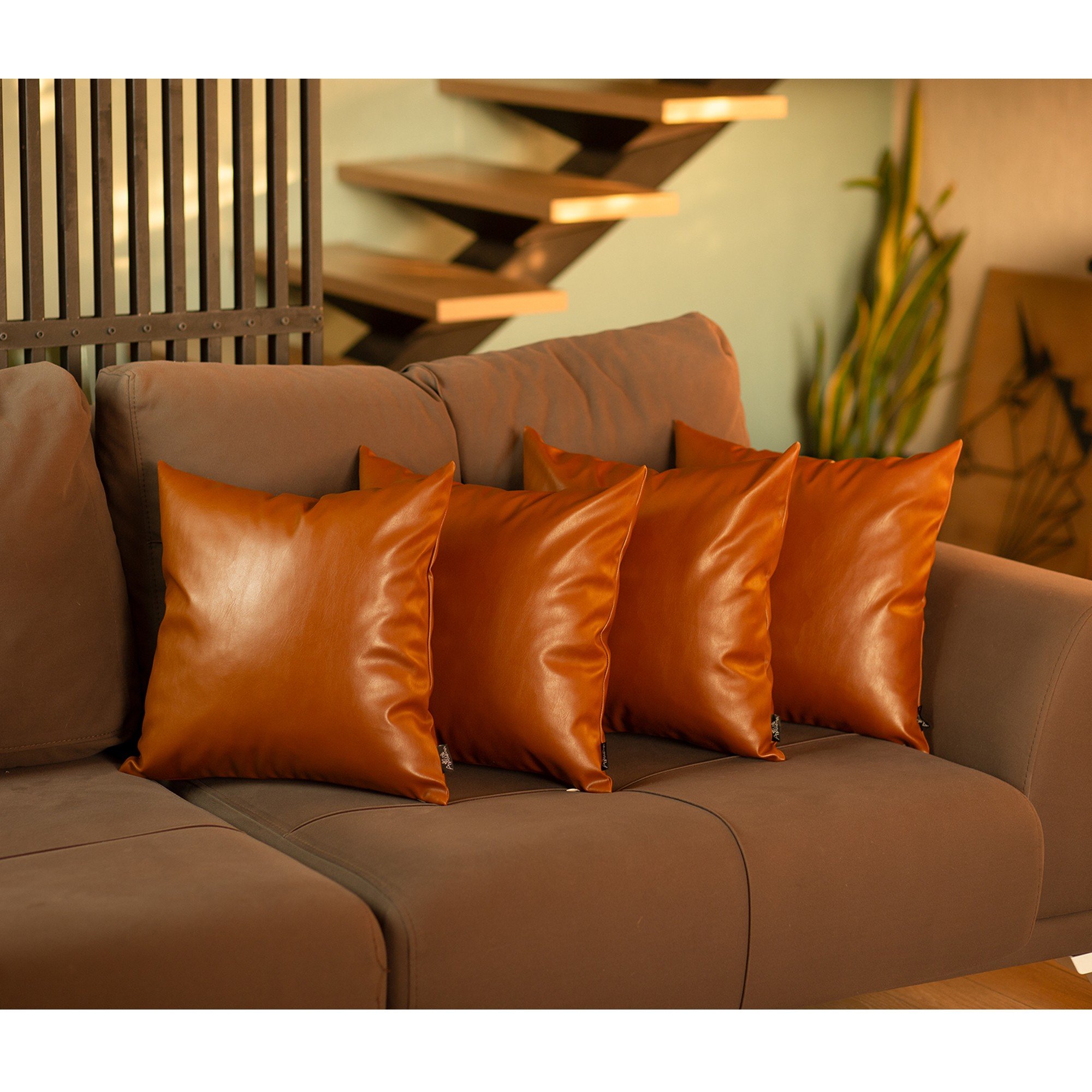 Set of 4 square brown faux leather pillow covers with hidden zipper closure, perfect for home decor.