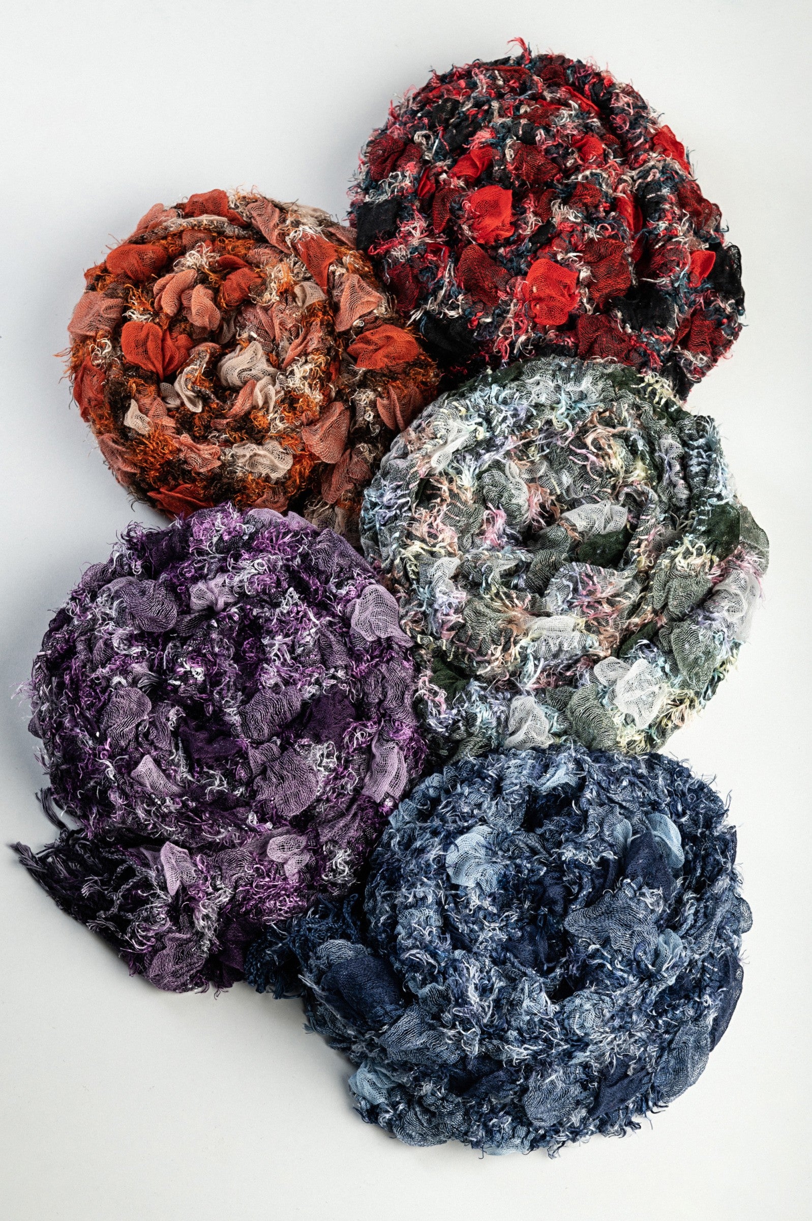 A colorful set of five scarves in red, orange, green, purple, and blue, made from soft 100% viscose material.