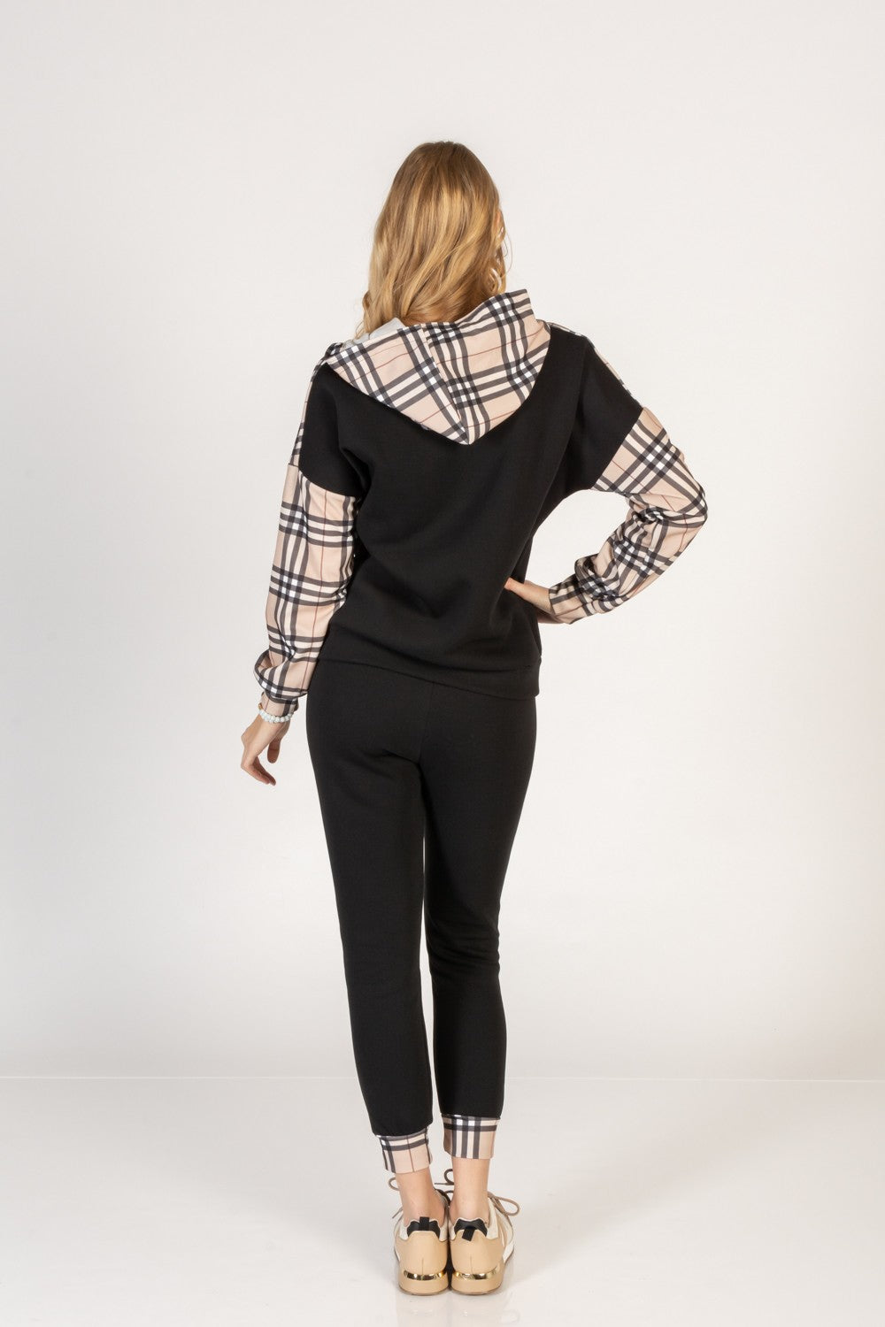 Black cotton tracksuit set featuring a checkered print T-shirt with long sleeves and zippered collar, paired with elastic waist pants with side pockets.