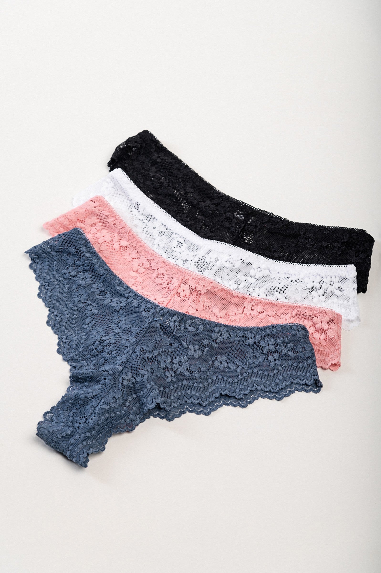 Set of four lace panties in various colors including red, beige, black, white, blue, and pink, showcasing their delicate lace design.