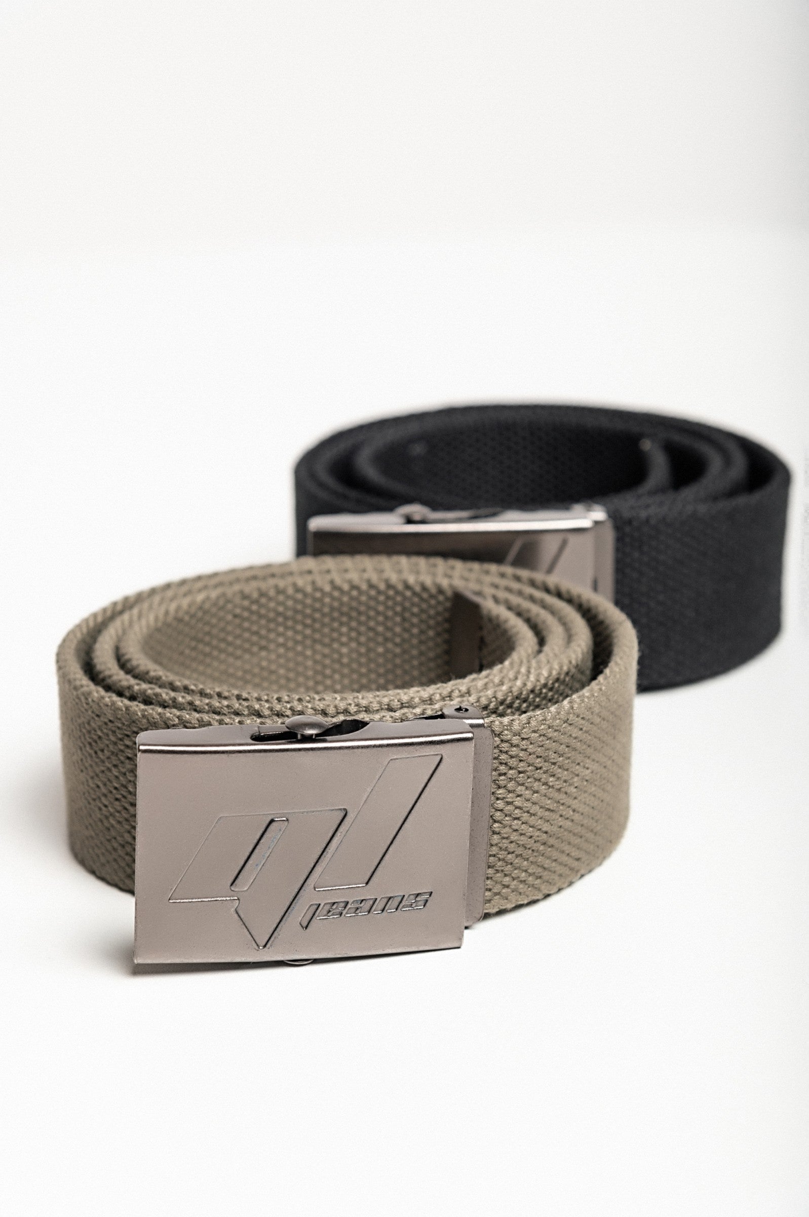 Set of two Ariol belts in green and black with metal buckles, showcasing their stylish design and durability.