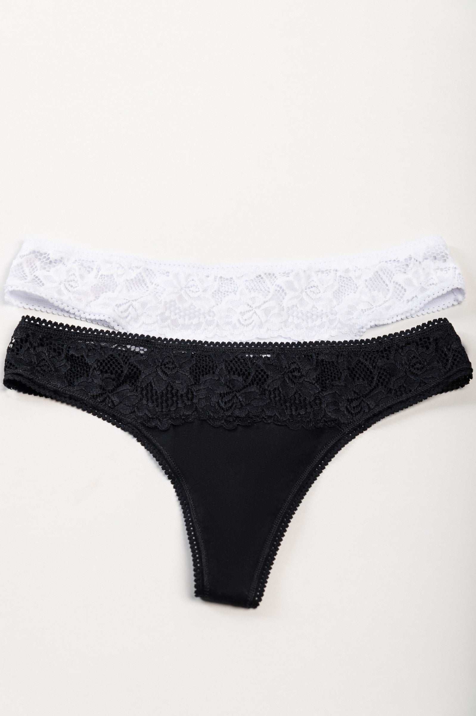 Set of two cotton thongs with lace in black and white, showcasing high-quality stretch cotton and elegant design.