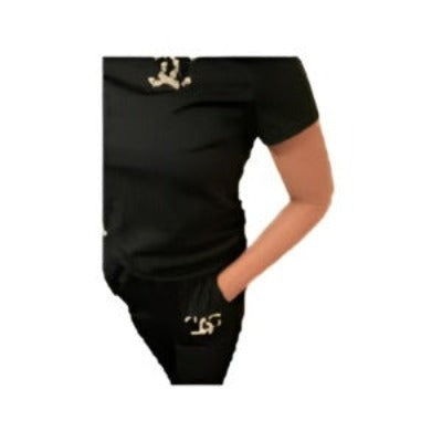 A stylish two-piece sexy outfit featuring a short sleeve top and long pants, designed with a round neck and Chanel logo.