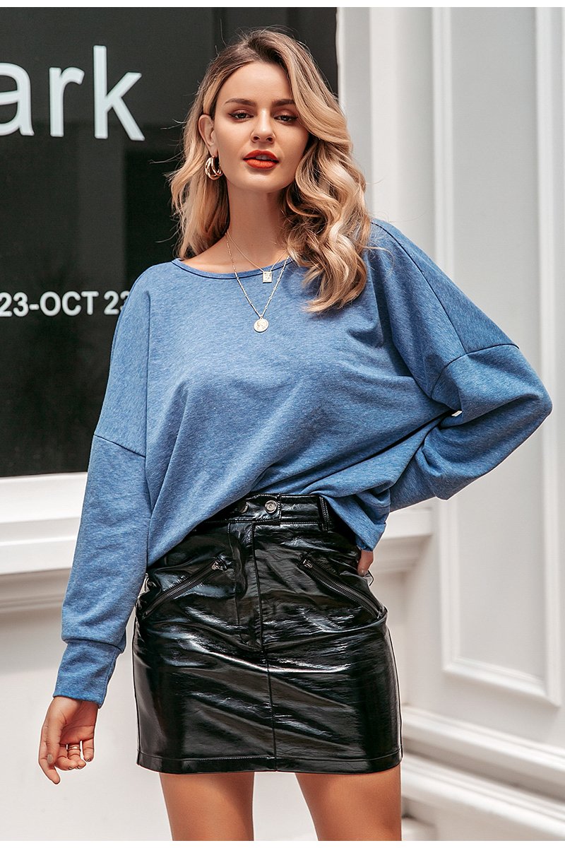 A stylish woman wearing a Sexy Back Hollow Out Long Sleeve Solid Tee, showcasing the unique hollow-out design and punk style.