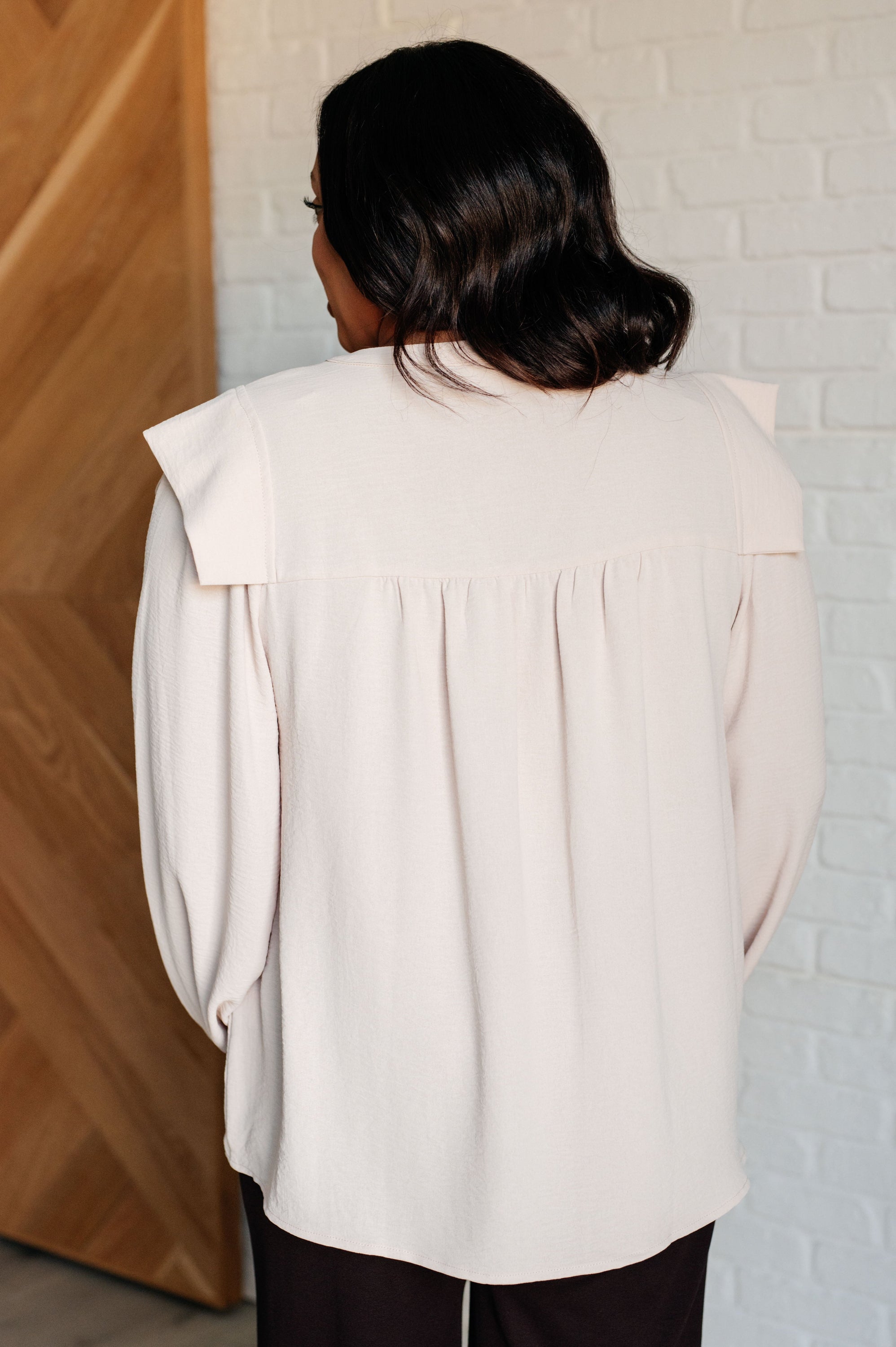 She Ought to Understand Balloon Sleeve Blouse featuring a V-neckline and long bishop sleeves in crinkle woven fabric.
