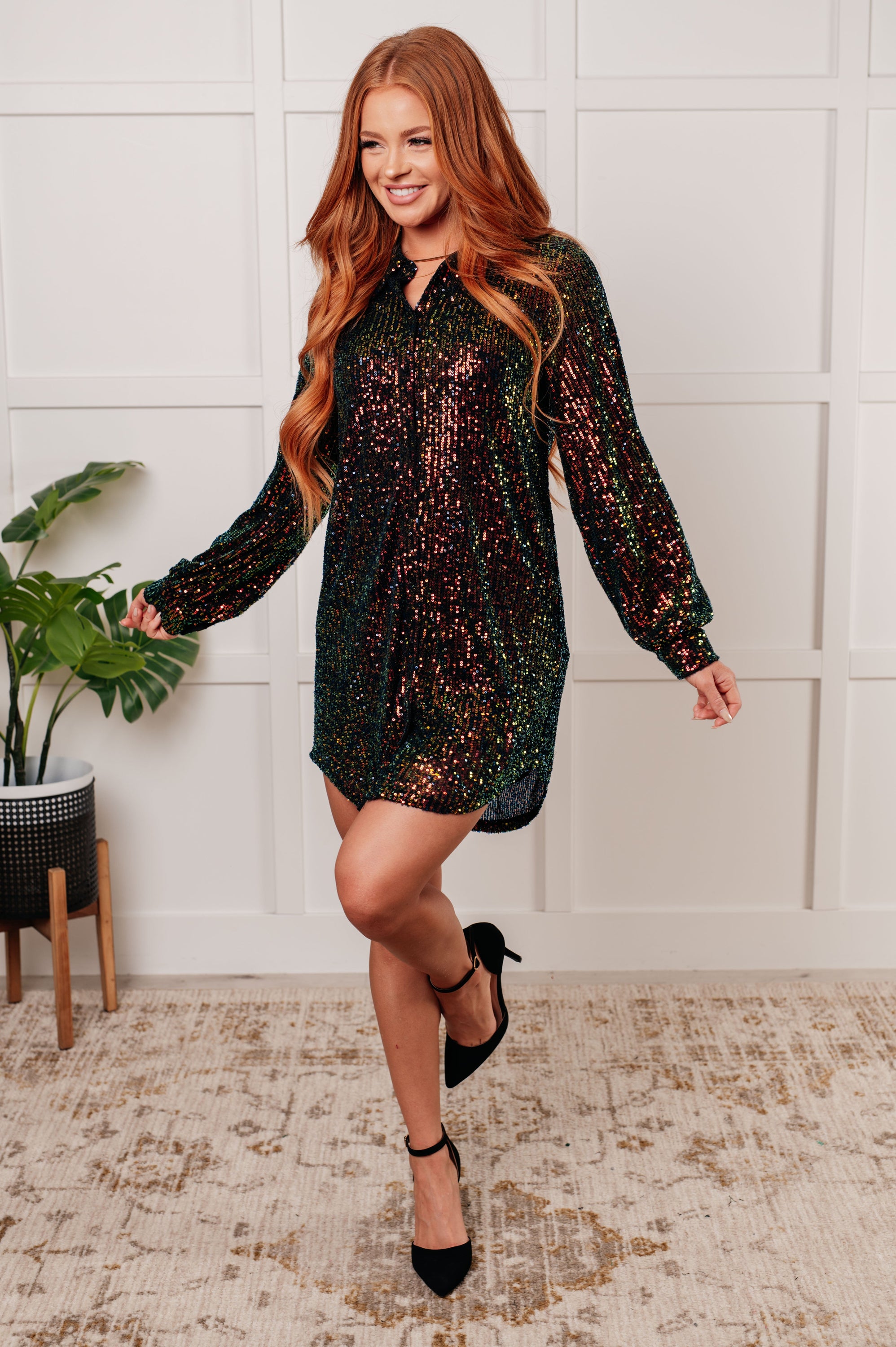 A glamorous Shimmering Splendor Sequin Shirt Dress featuring a collared neckline, long sleeves, and a shimmering sequin design.