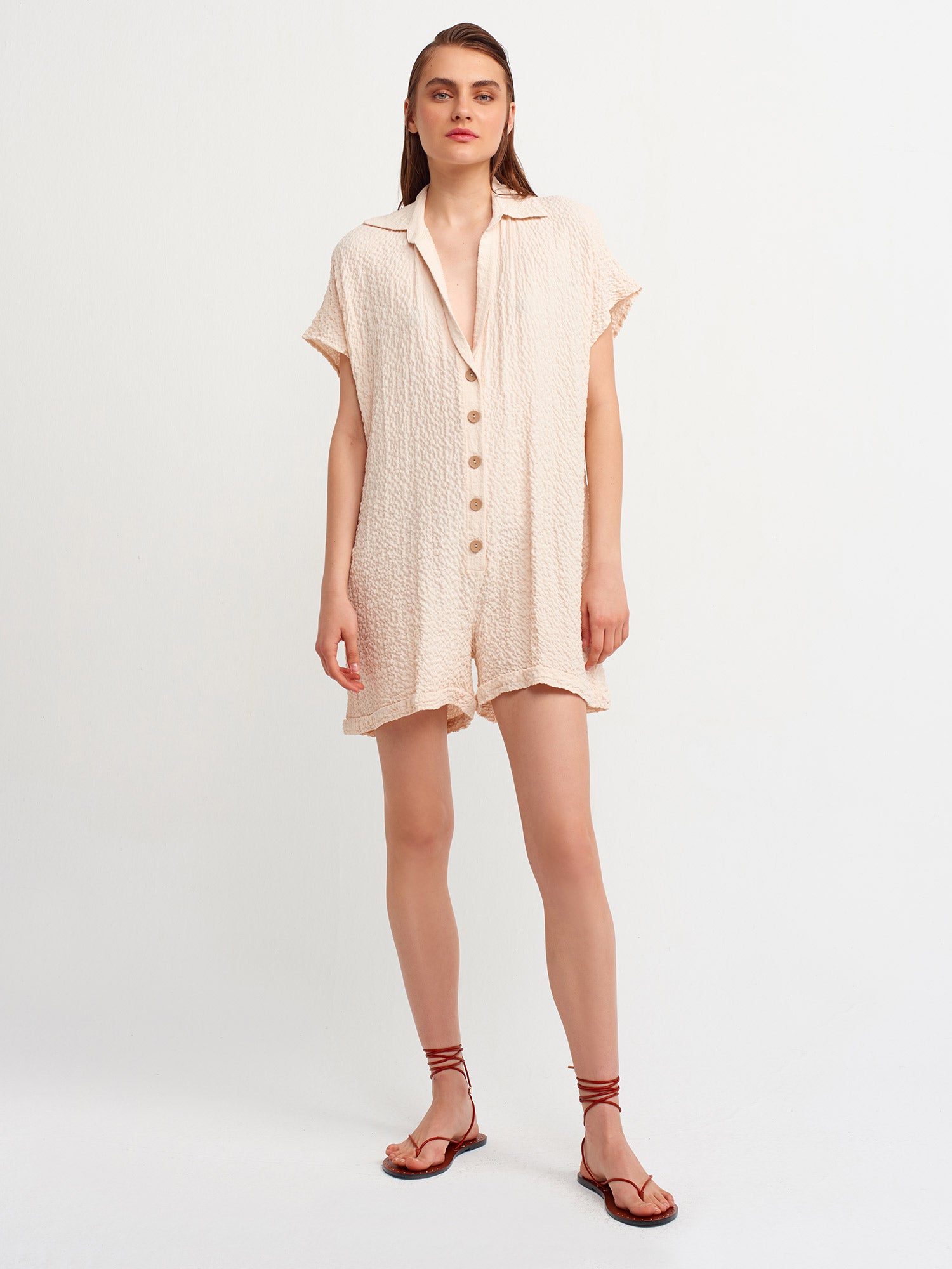 A stylish shirt collar jumpsuit made from 99% Viscose and 1% Elastane, featuring a tailored fit and elegant design.