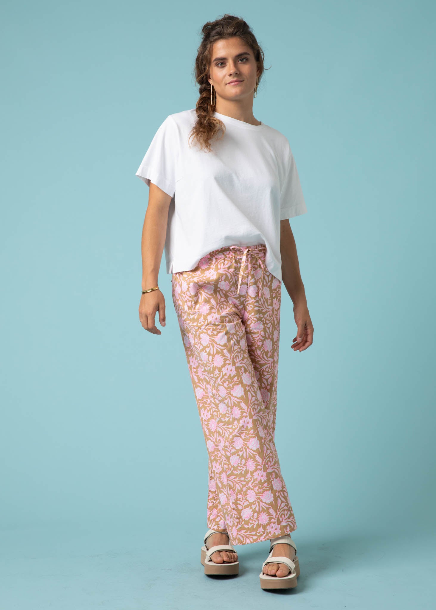 Shore Pant in Floral Escape featuring a vibrant Baked Clay and Neon Pink floral pattern, showcasing a relaxed fit and modern cropped length.