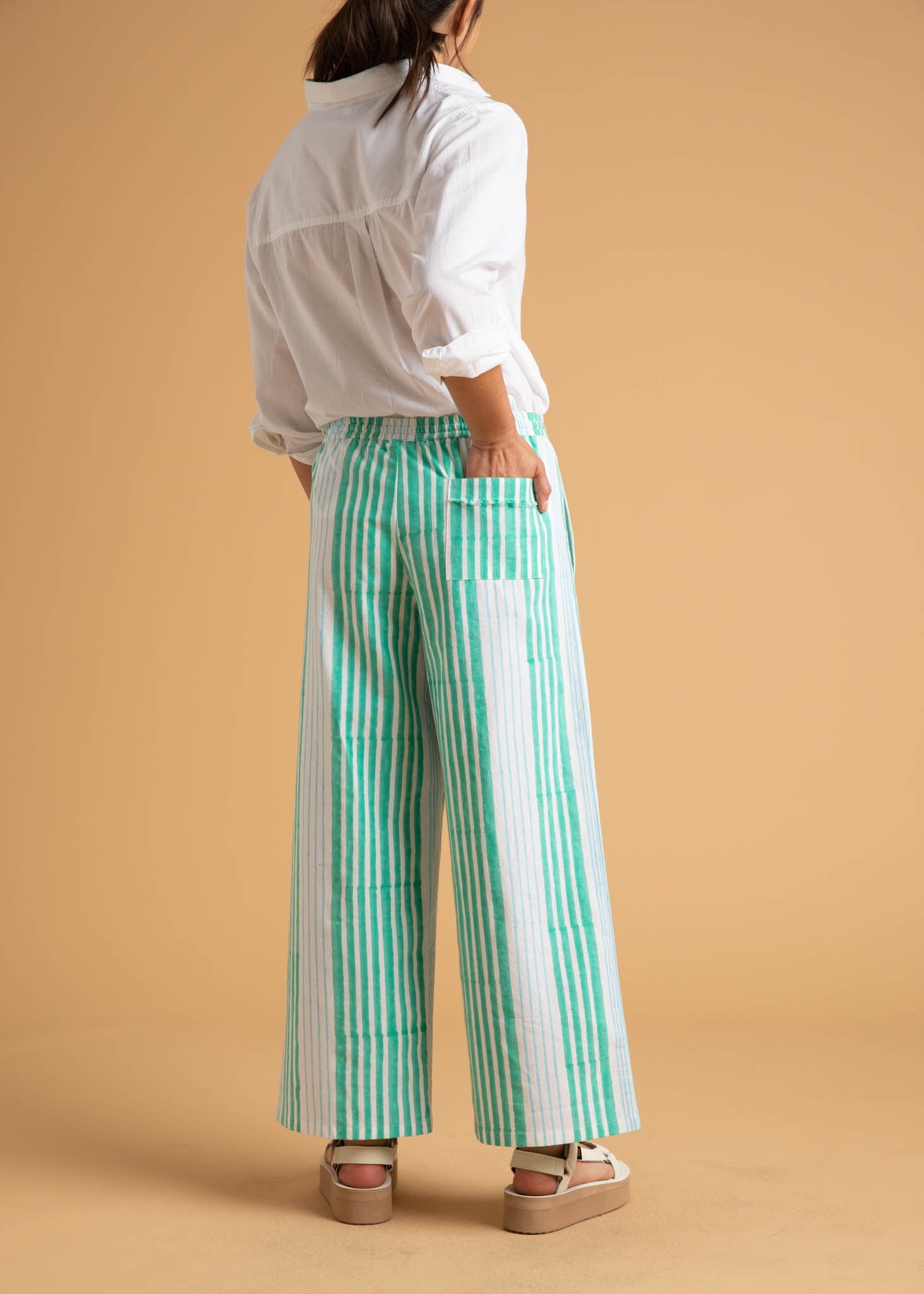 Shore Pant in Mixed Up Stripe featuring Seaglass and Cerulean colors, showcasing its relaxed fit and modern cropped length.