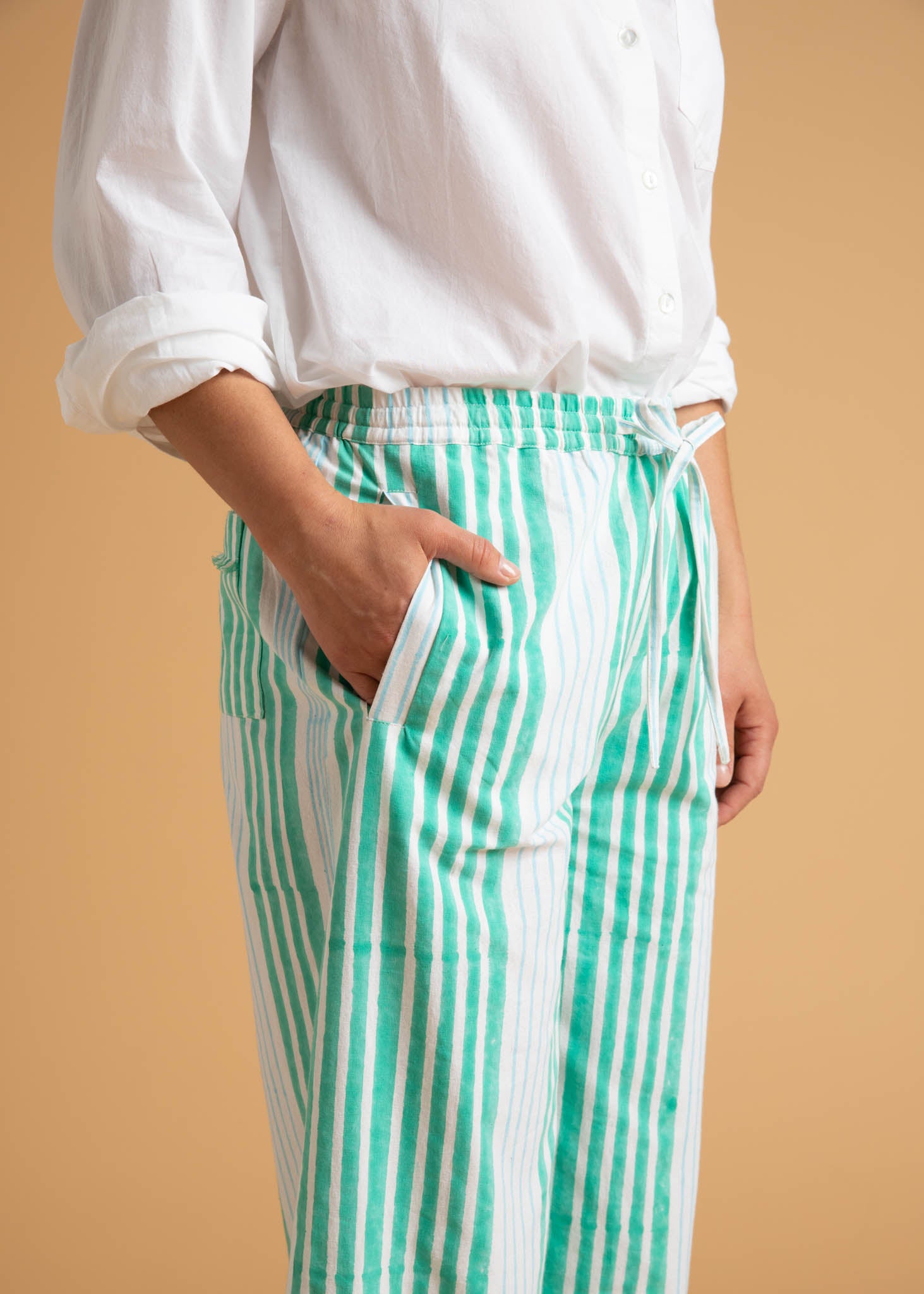 Shore Pant in Mixed Up Stripe featuring Seaglass and Cerulean colors, showcasing its relaxed fit and modern cropped length.