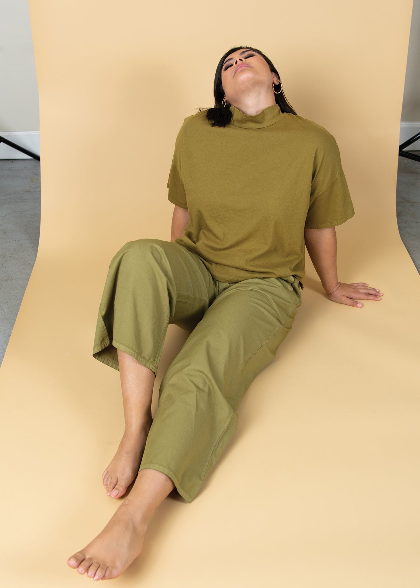 Shore Pant in Olive Oil Twill, showcasing its relaxed fit, cropped length, and elastic waist design.