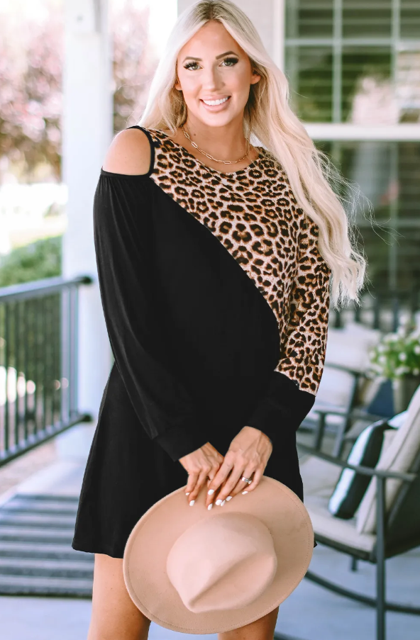 A stylish black mini dress featuring a trendy leopard print design, round neckline, and long sleeves, perfect for various occasions.