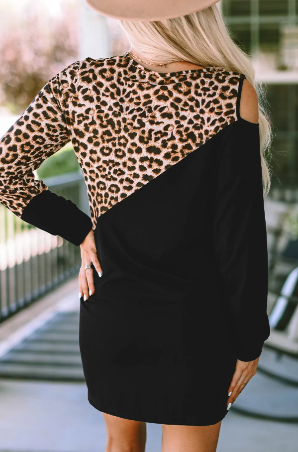 A stylish black mini dress featuring a trendy leopard print design, round neckline, and long sleeves, perfect for various occasions.