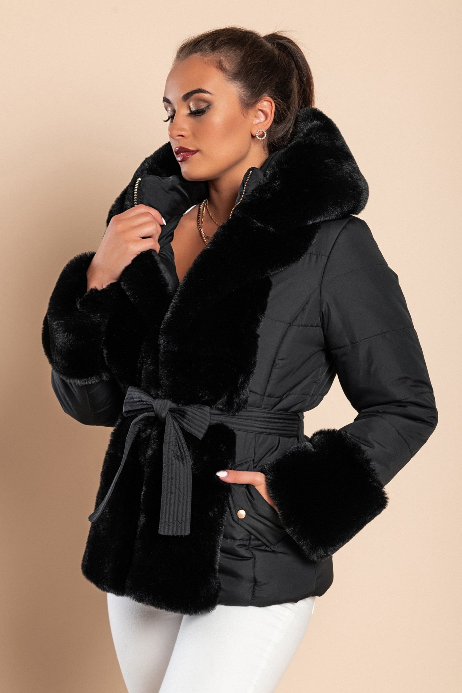 Black short padded jacket with faux fur trim, featuring a quilted design, side pockets, and a stylish belt.