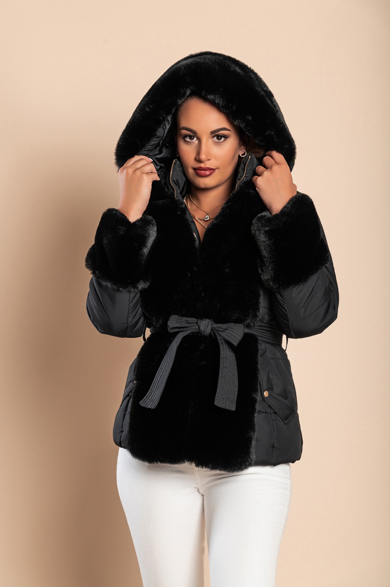 Black short padded jacket with faux fur trim, featuring a quilted design, side pockets, and a stylish belt.