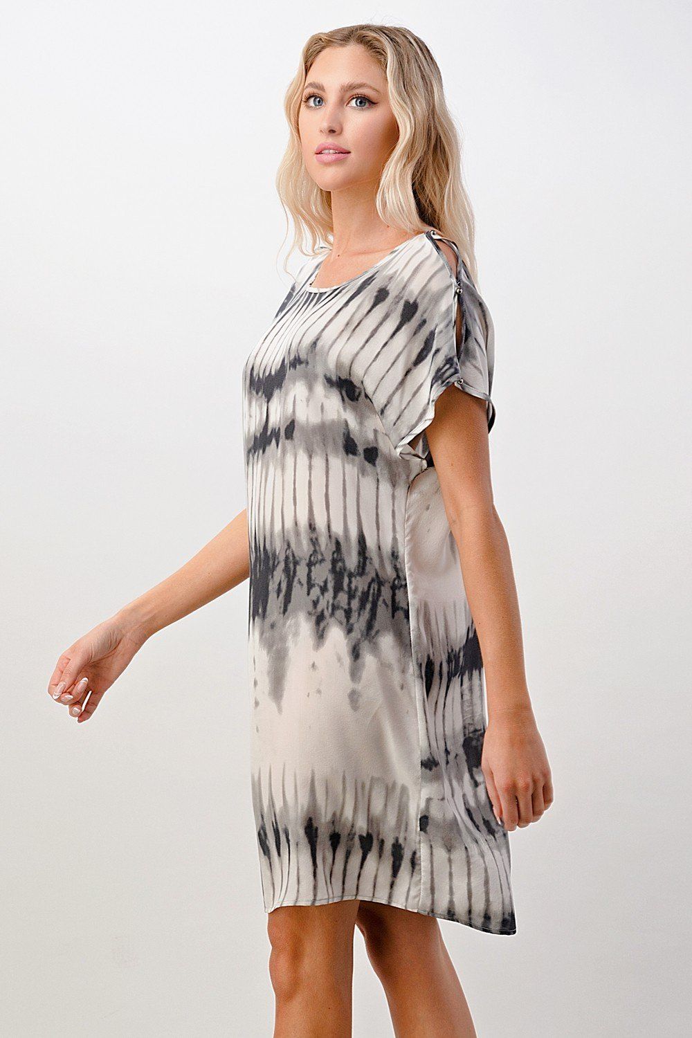 A stylish short sleeve tie-dye shift dress displayed on a model, showcasing its vibrant colors and relaxed fit.